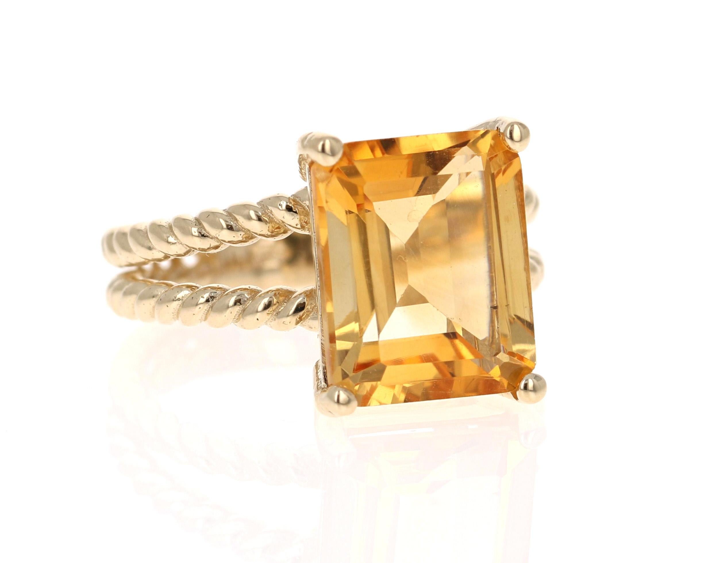This beautiful, designer inspired ring has a bright and vivid Emerald Cut Citrine Quartz in the center that weighs 5.31 Carats. 
The setting is beautifully crafted in 14K Yellow Gold and weighs approximately 5.2 grams.
The ring is a size 7 and can