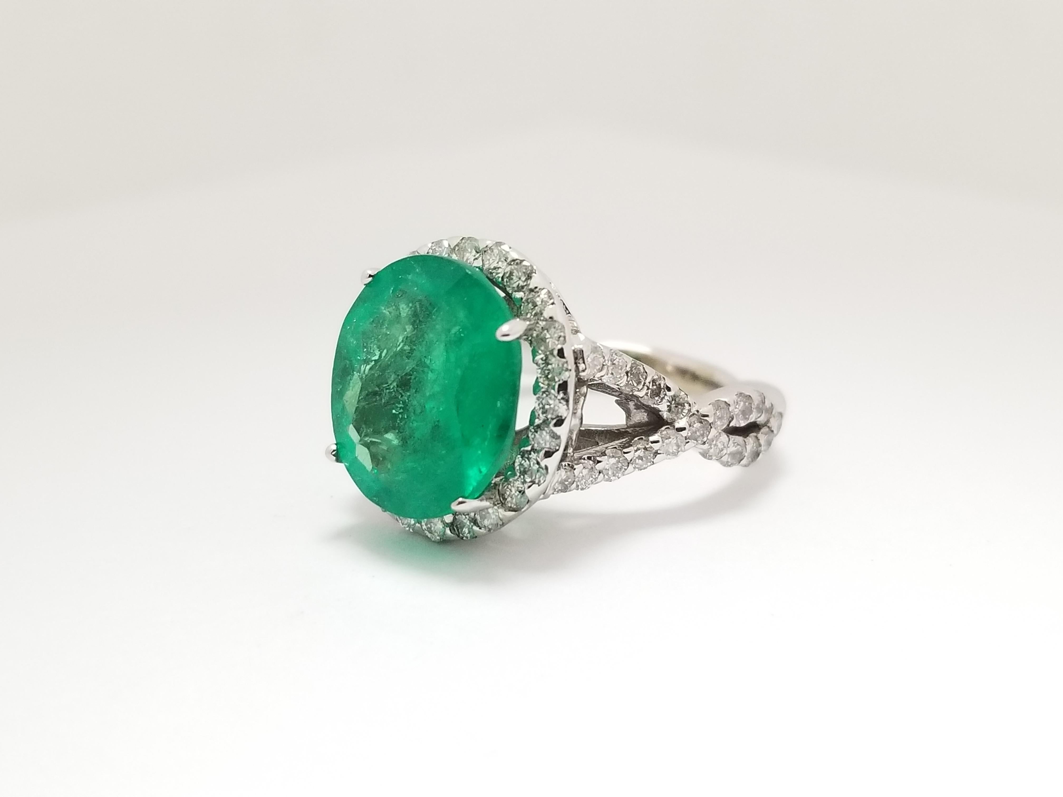 Fabulous 5.31 carats of natural beautiful color Genuine Colombian Green Emerald surrounded by 1.35 cttw of natural white diamonds in halo ring. Setting 14 Karat white gold.

5.31 CTS OVAL SHAPE GENUINE COLOMBIAM EMERALD DIAMOND RING 14K
1.35 CCTW