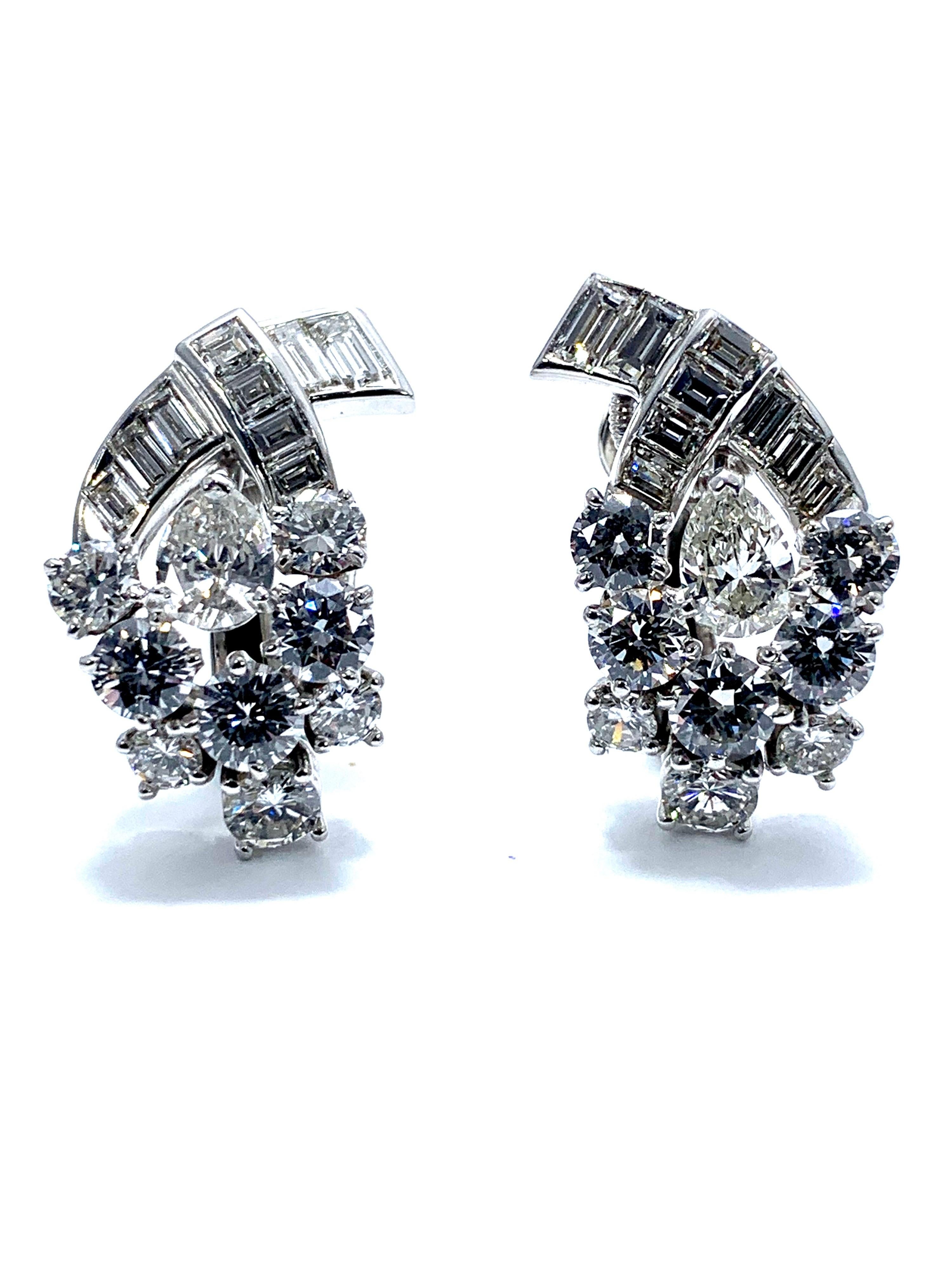 A gorgeous pair of various shaped Diamond and platinum clip earrings.  The 5.32 carats in Diamonds consist of round brilliants, pear shapes, and baguettes.  they are graded as G-H color, VS-SI1 clarity.    The earrings feature a hinged clip back, to