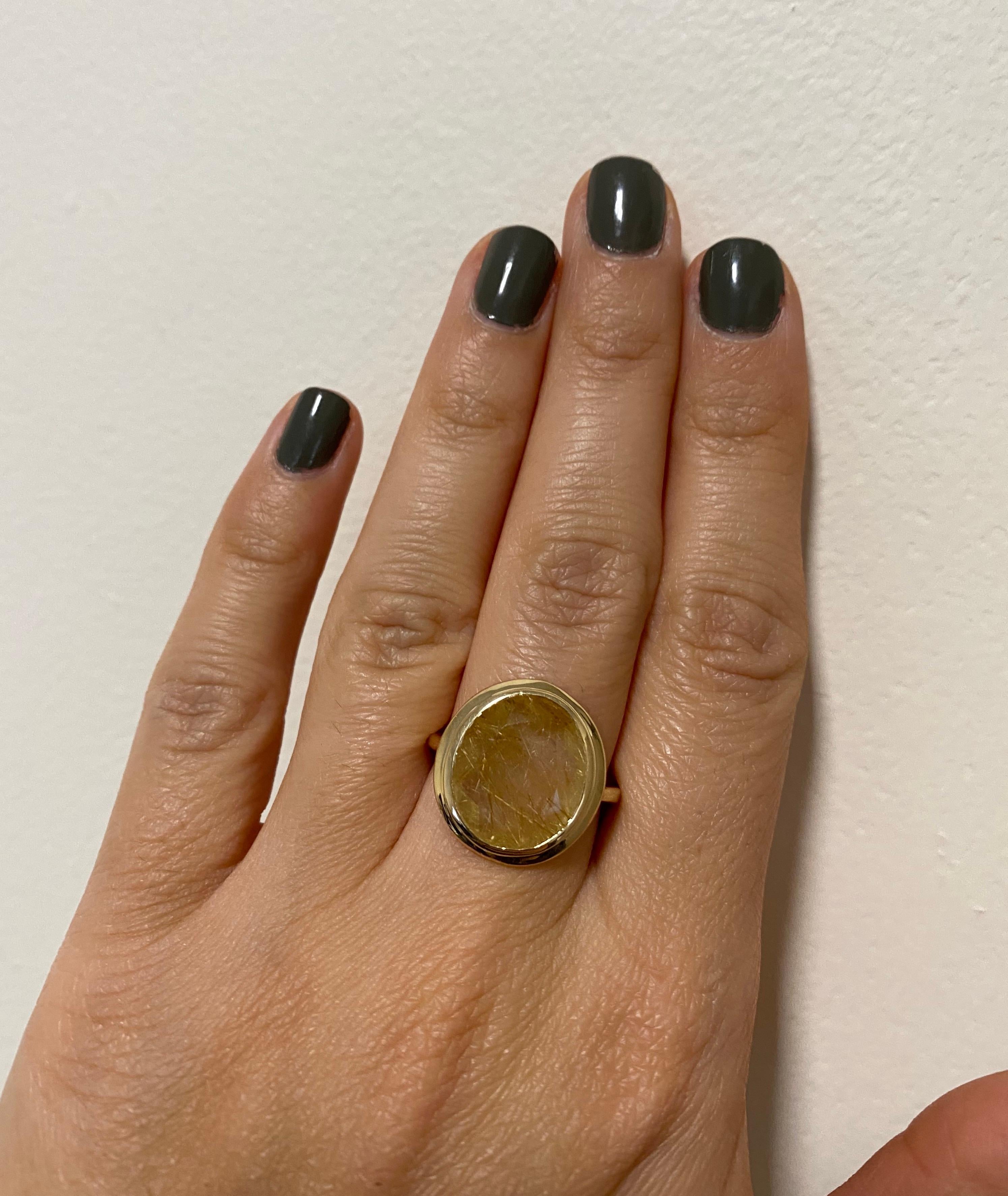 Material: 14k Yellow Gold 
Stone Details: 1 Oval Rutilated Quartz at 5.32 Carats - Measuring 12 x 14 mm.
This piece measures approximately 20 x 17 mm.
Alberto offers complimentary sizing on all rings.

Fine one-of-a-kind craftsmanship meets