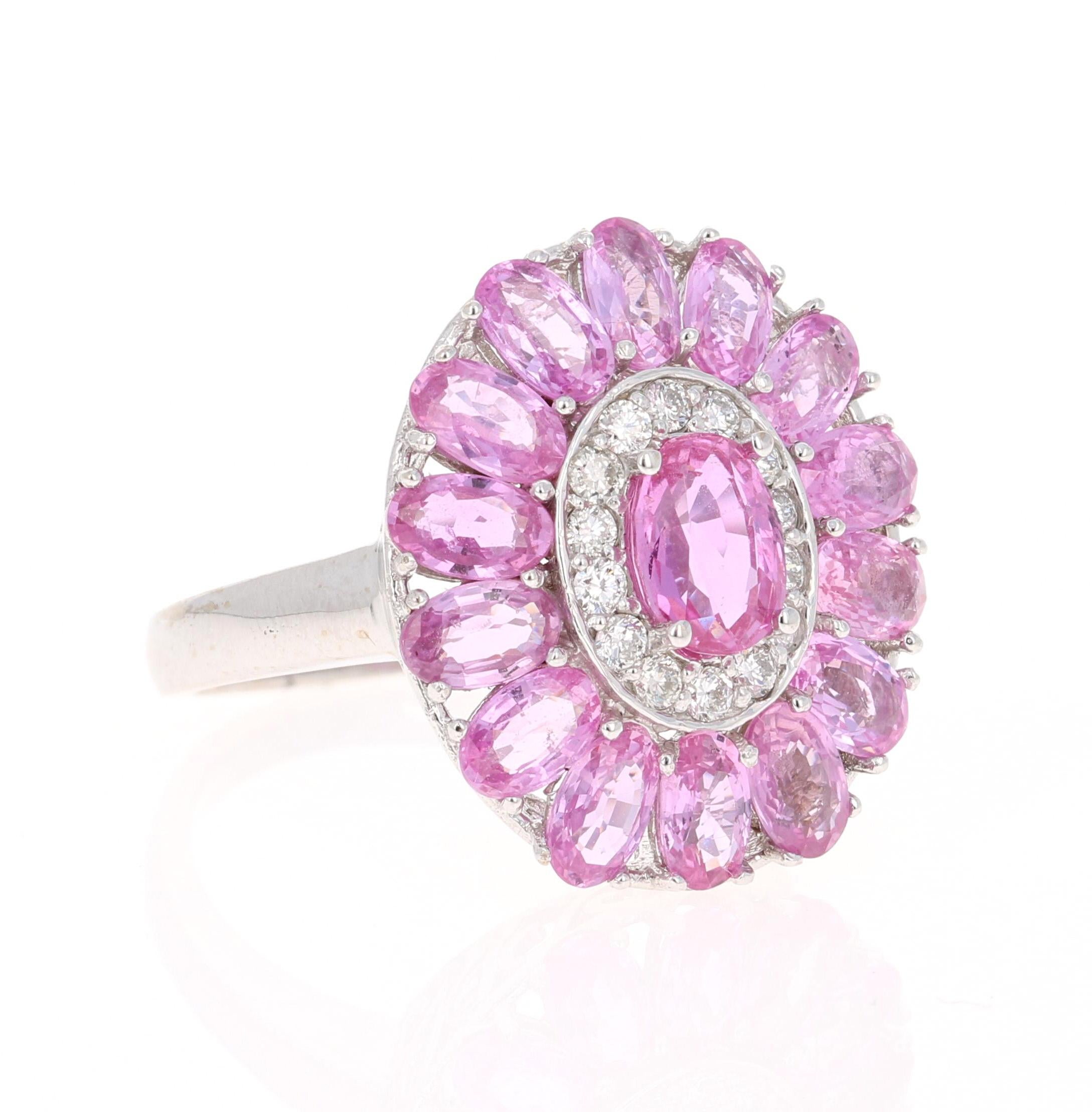 This beautiful ring has a Pink Sapphire that weighs 1.05 Carats that measures at 5 mm x 7 mm (width x length) and 14 Pink Sapphires floating around that weigh 4.00 Carats, as well as 14 Round Cut Diamonds that weigh 0.27 Carats. (Clarity: VS, Color: