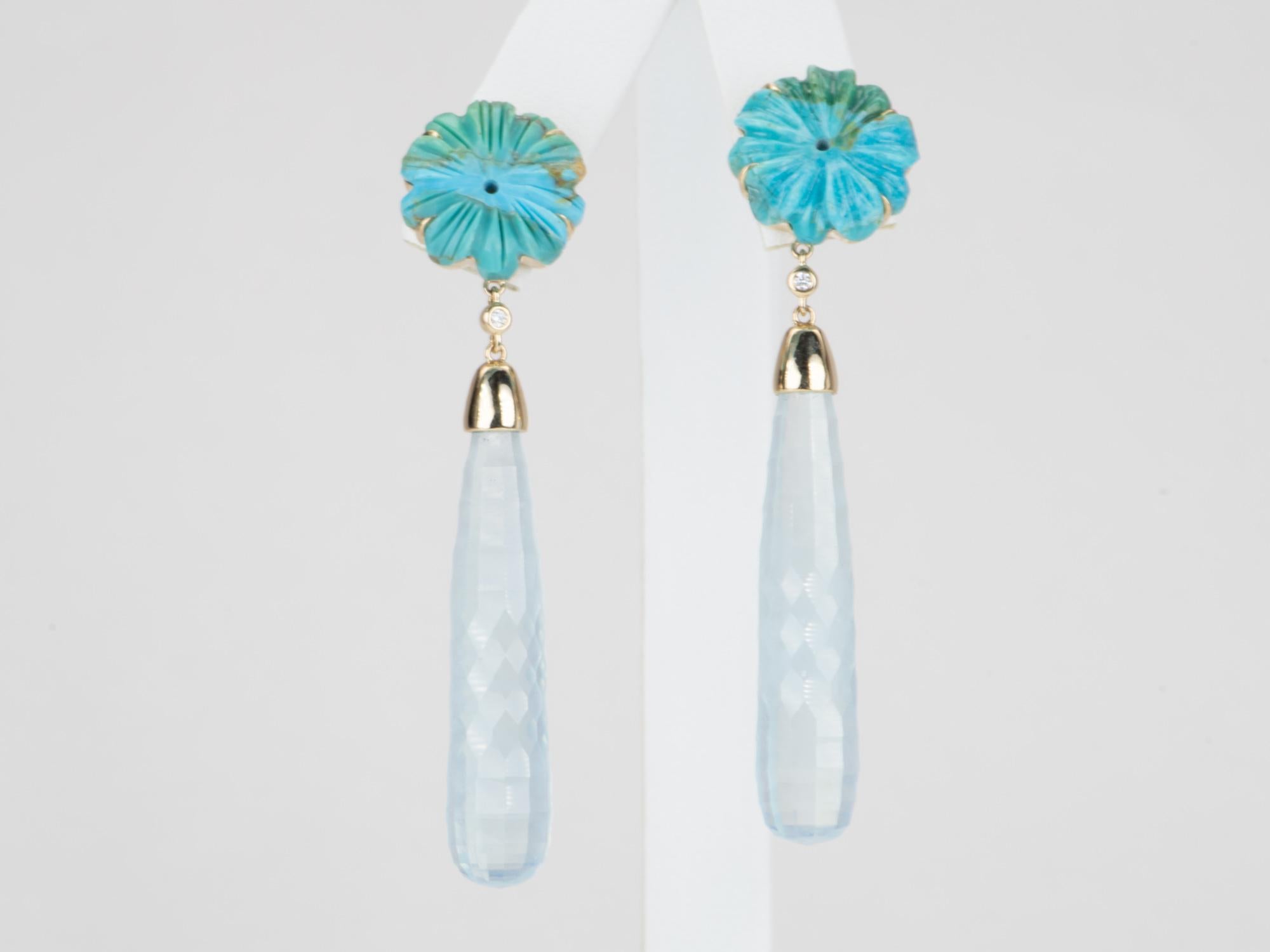Make a statement with these long aquamarine and turquoise earrings! An awe-inspiring sight to behold, it's like nature herself inspired their unique carving pattern. Perfect for any occasion, these long beauties are set in 14k gold to highlight
