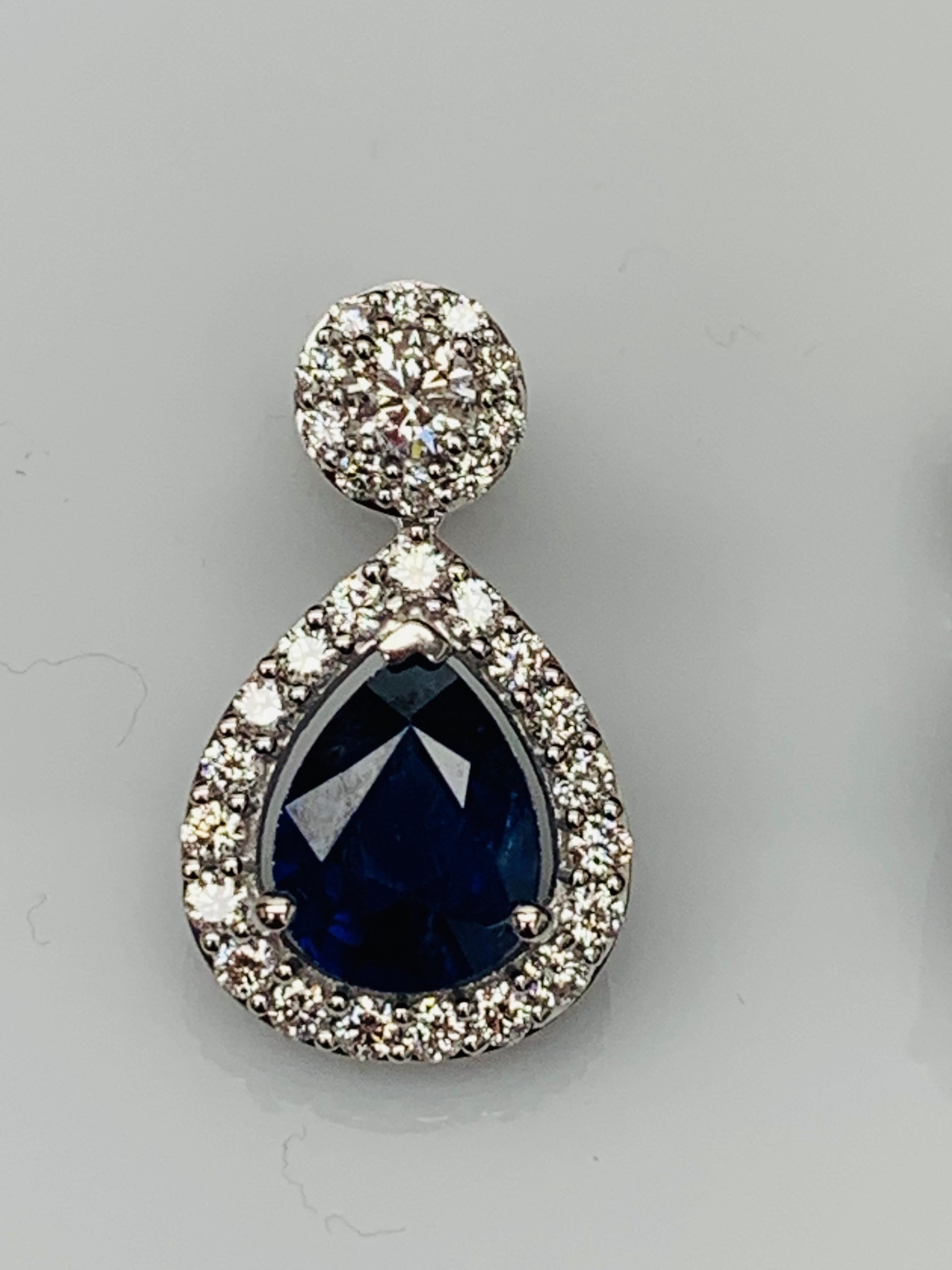 A beautiful and chic pair of drop earrings showcasing brilliant-cut diamonds, and pear shape Blue Sapphires set in an intricate and stylish design. 2  Diamonds on the top weigh 0.38 carats in total.  2  Blue sapphires weigh 5.34 carats in total.
