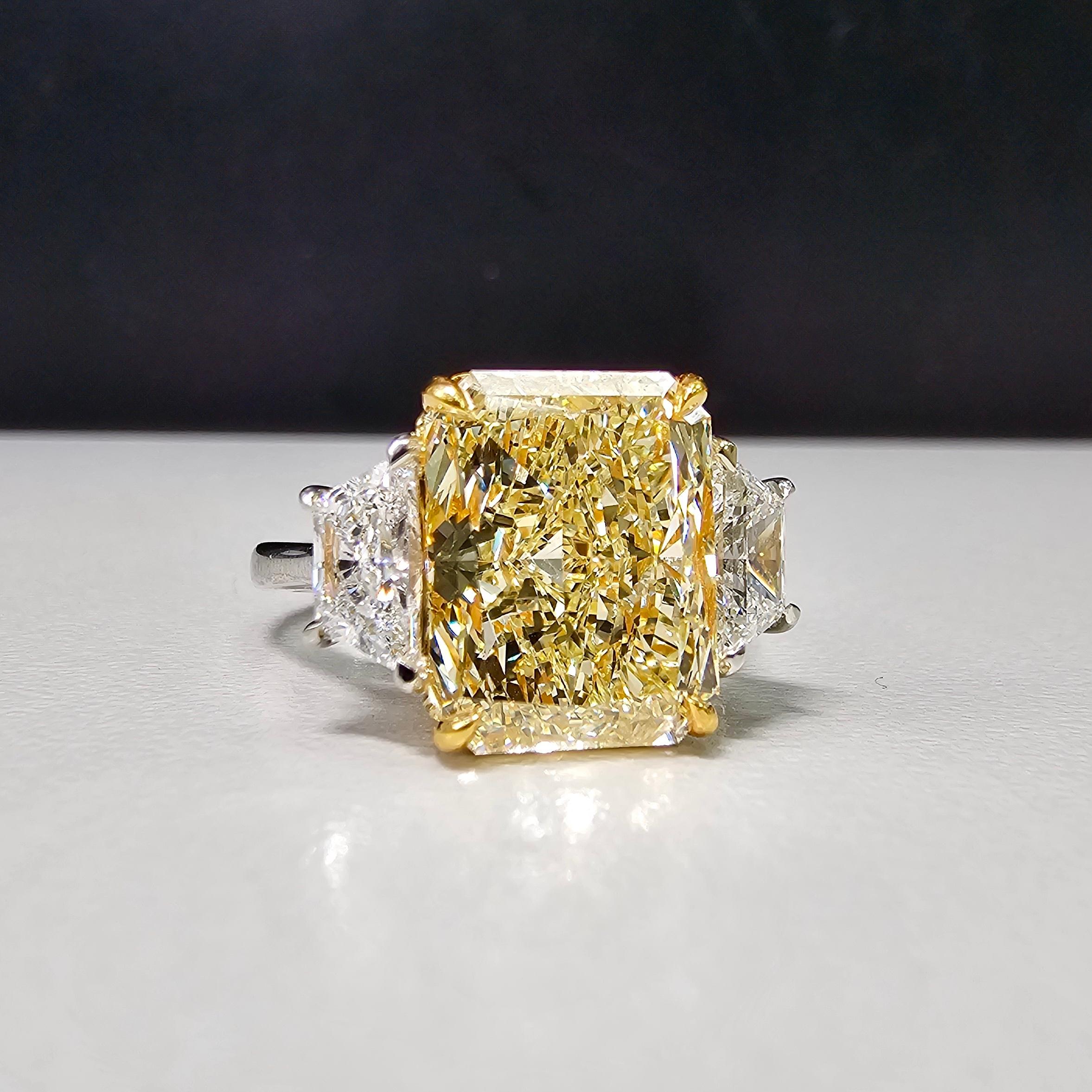 6.27 Total Carat Weight
5.34 Carat Fancy Light Yellow Elongated Radiant Cut Center Diamond
0.93 Carats of White (D) Trapezoids
VS2 Clarity
GIA Certified Diamond
Crafted in Platinum and 18k Gold 
Handmade in NYC 

This piece can be viewed before