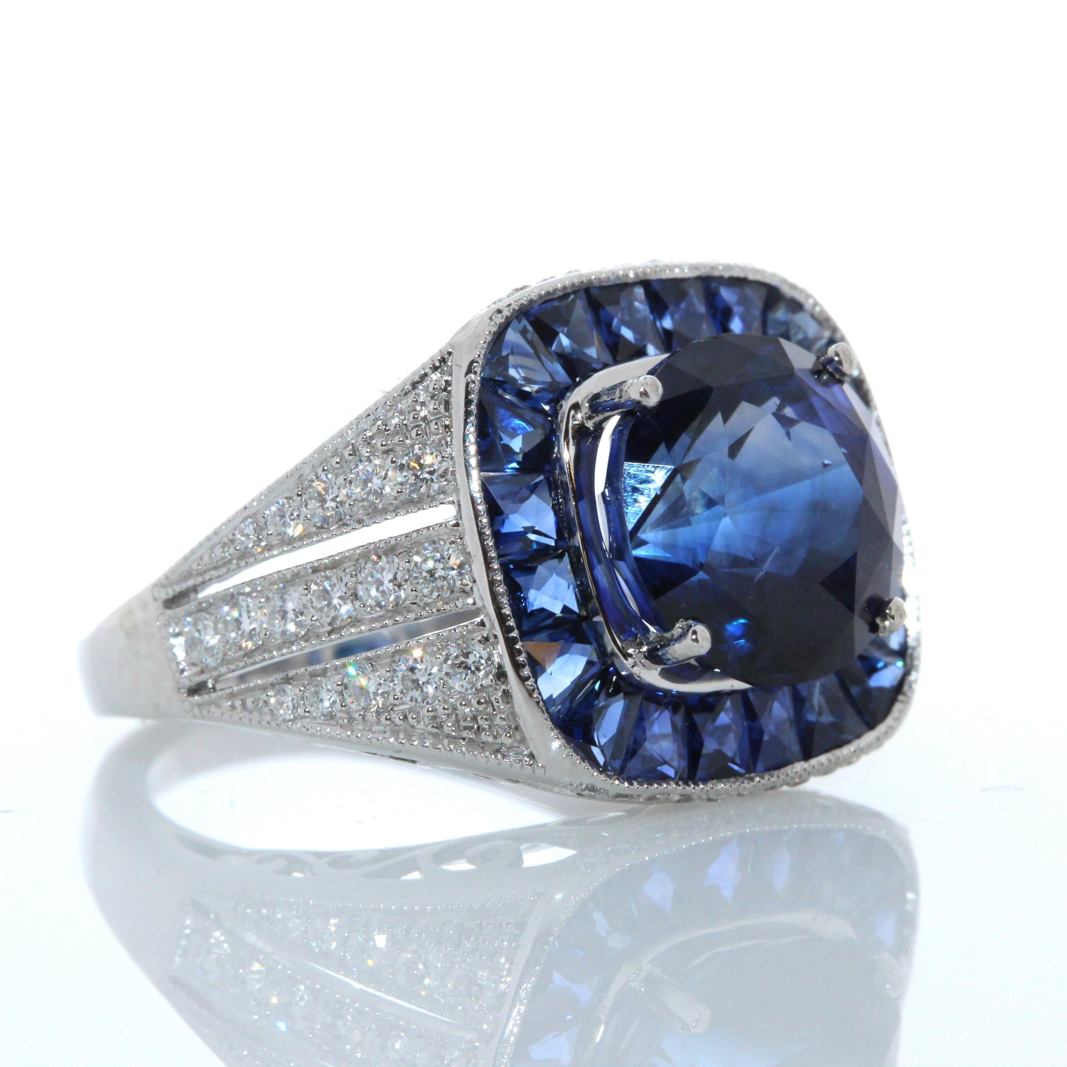 This is a 5.35 carats royal blue sapphire that is surrounded by a stunning halo of round brilliant diamonds. This spectacular Platinum custom made ring truly displays the incredible beauty of the round shaped Blue Sapphire. The 0.46 carat total