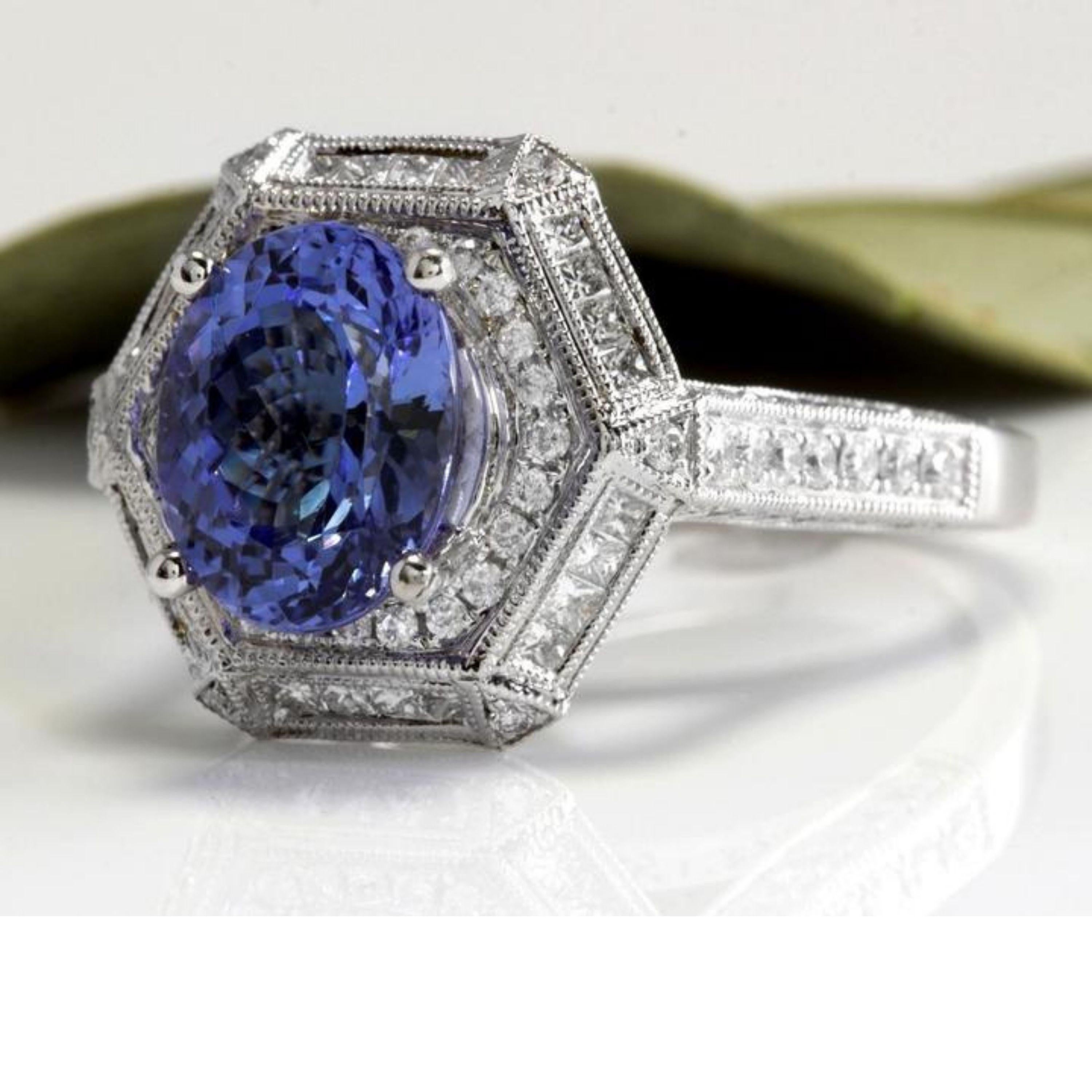 5.35 Carats Natural Very Nice Looking Tanzanite and VS1 Diamond 18K Solid White Gold Ring

Total Natural Oval Cut Tanzanite Weight is: 3.50 Carats

Natural Round & Princess Diamonds Weight: 1.85 Carats (color F-G / Clarity VS1

Ring size: 7 (we