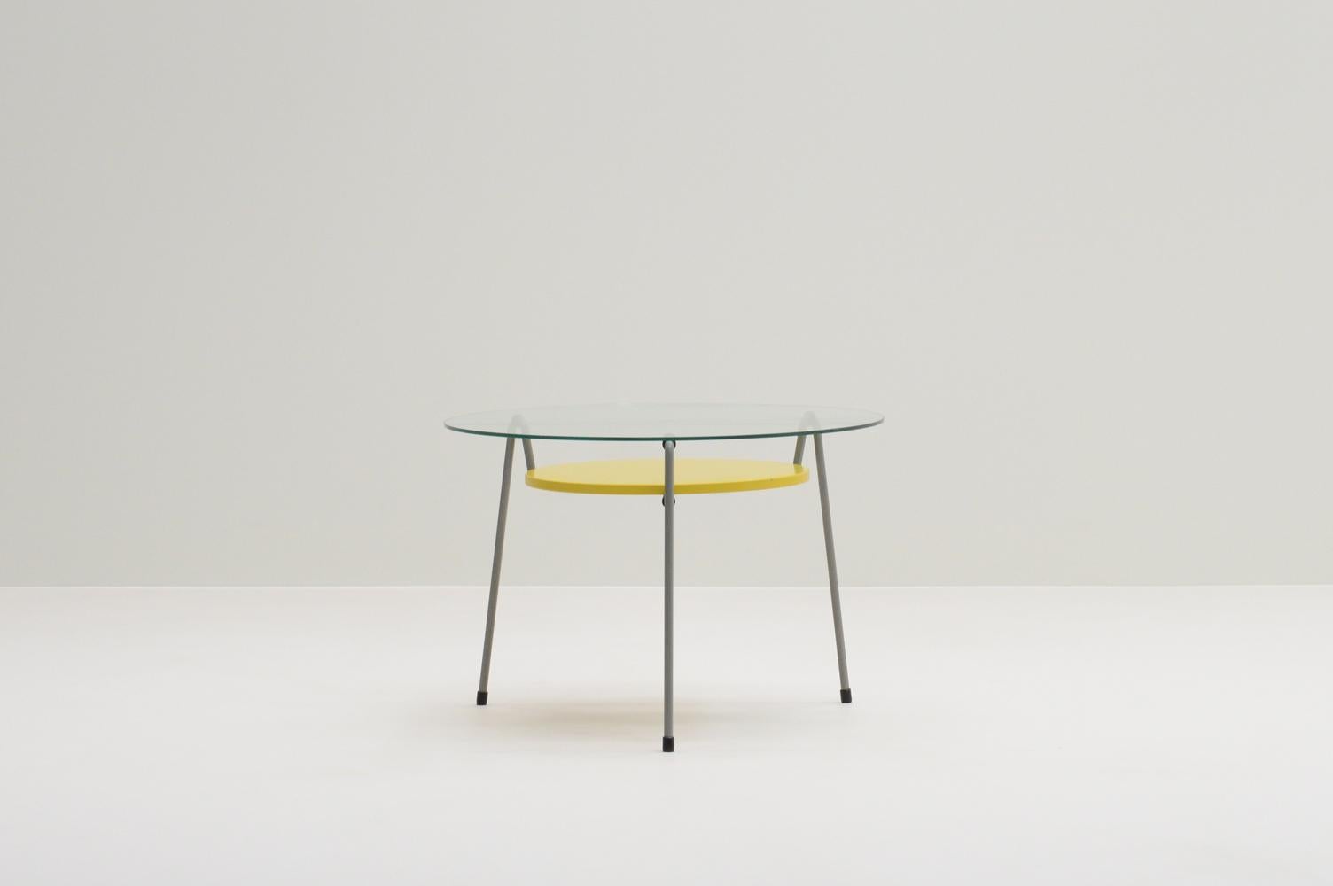 535 table by Wim Rietveld for Gispen, The Netherlands 50s. In 1953 Wim Rietveld designed the Model 535 side table, also known as the “Mug” (mosquito) table. Grey 3-legged table with yellow metal tray and its original glass top. Has been refinished