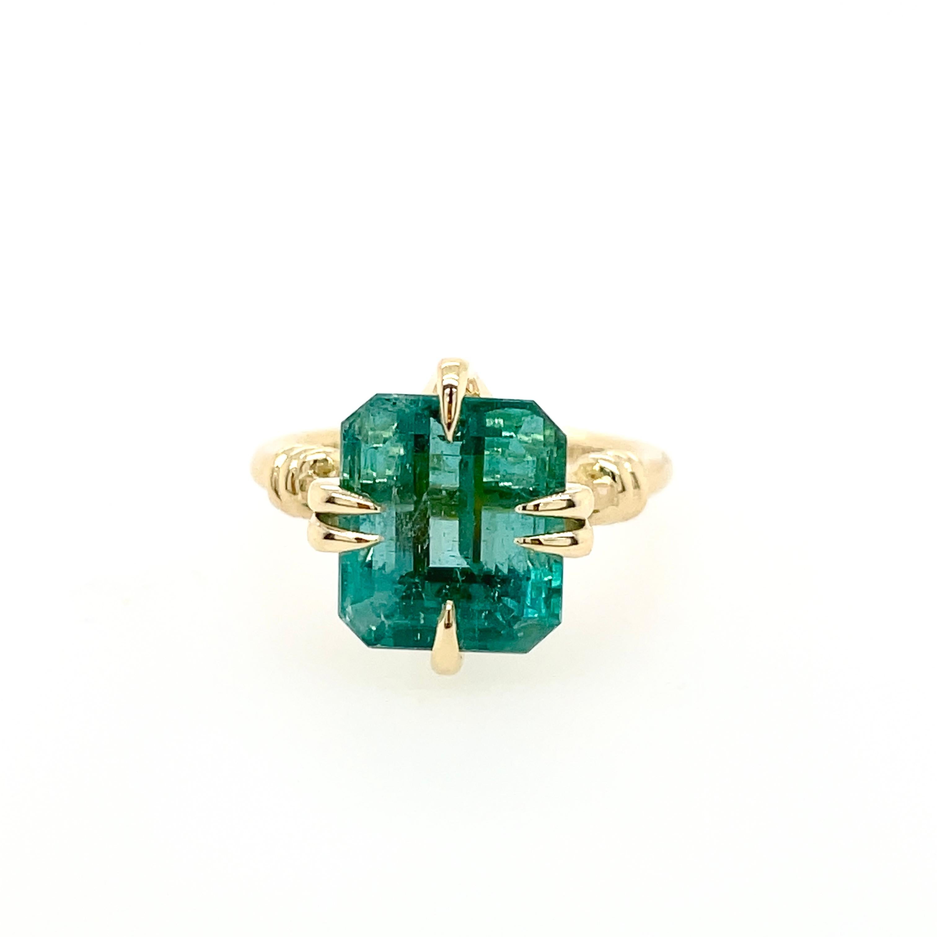 Glamorously bold and unabashedly seductive. This showstopper ring features an 5.35ct emerald cut Zambian emerald  poised between sharp eagle style talons and embraced by powerful golden reefs knotted ropes.

Handcrafted in 18ct yellow gold
Ethically