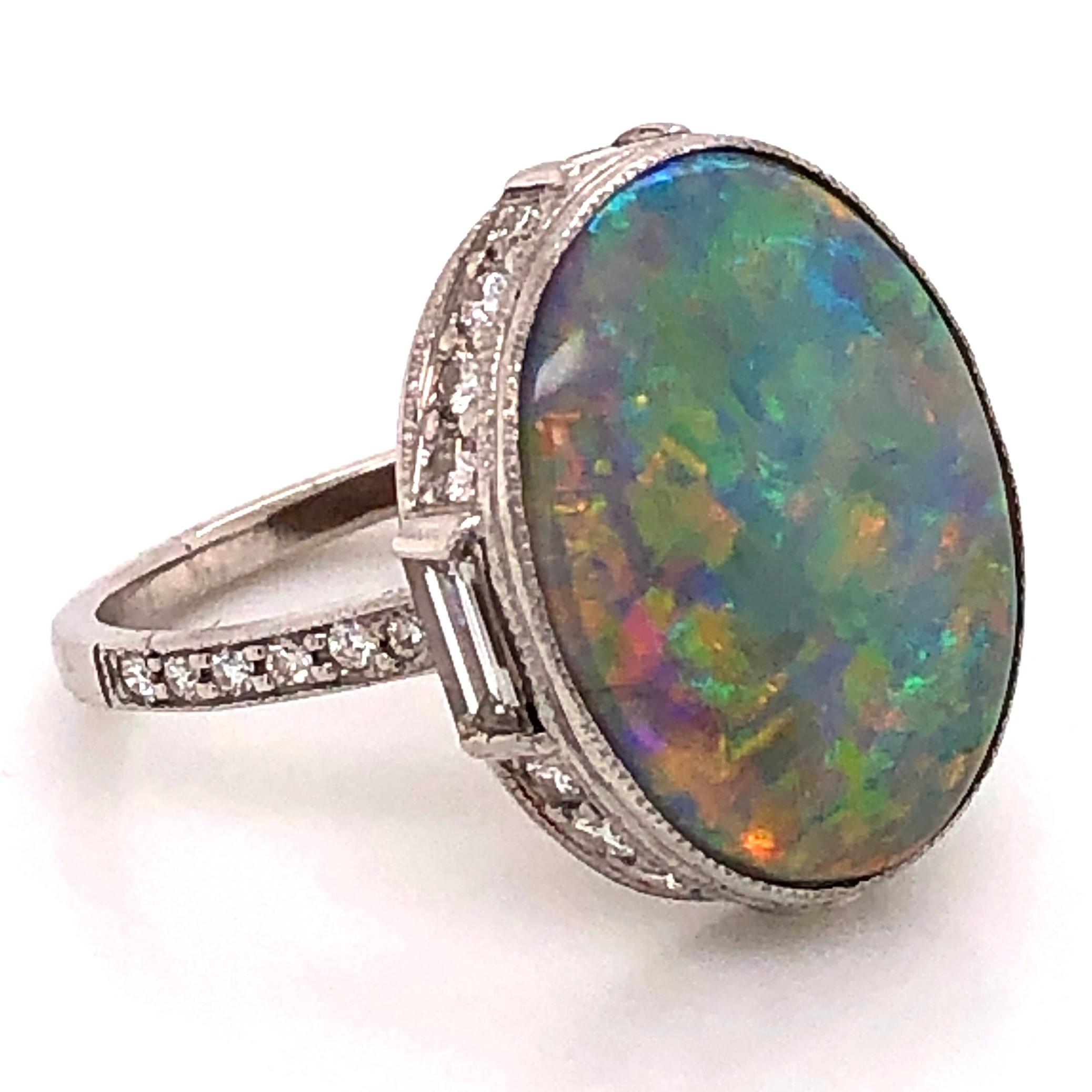 Fabulous Dark Gray Opal and Diamond Cocktail Ring. Securely set with a 5.37 Carat Opal, beautifully accented surround of round and baguette Diamonds, weighing approx. 1.15tcw. Finely detailed Hand crafted Platinum mounting. Ring measures approx.