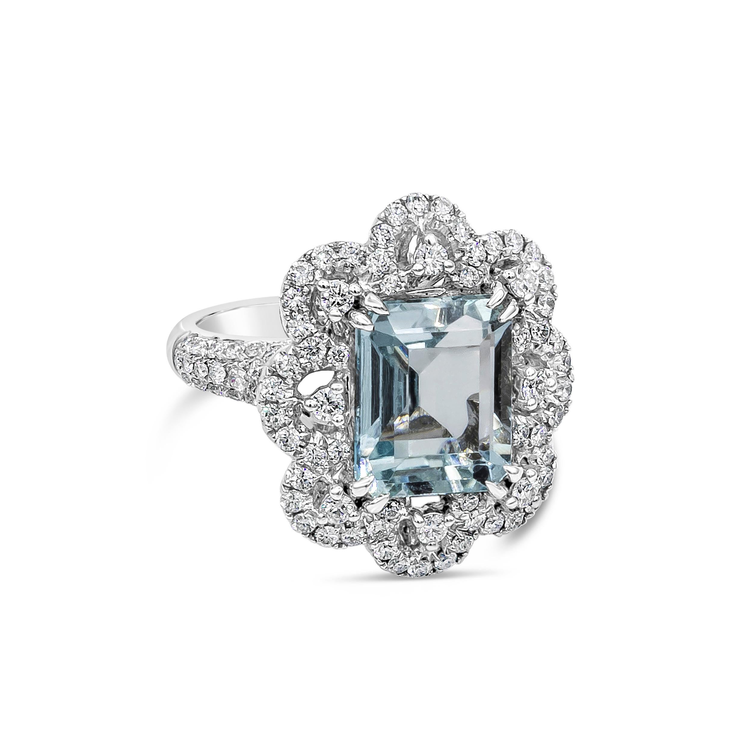 A splendid cocktail ring, featuring a 5.37 carats emerald cut aquamarine, set on an eight prong basket setting. Accented by 126 round brilliant cut diamonds weighing 1.88 carats total, set beautifully with a floral motif. Finely made with 18K white