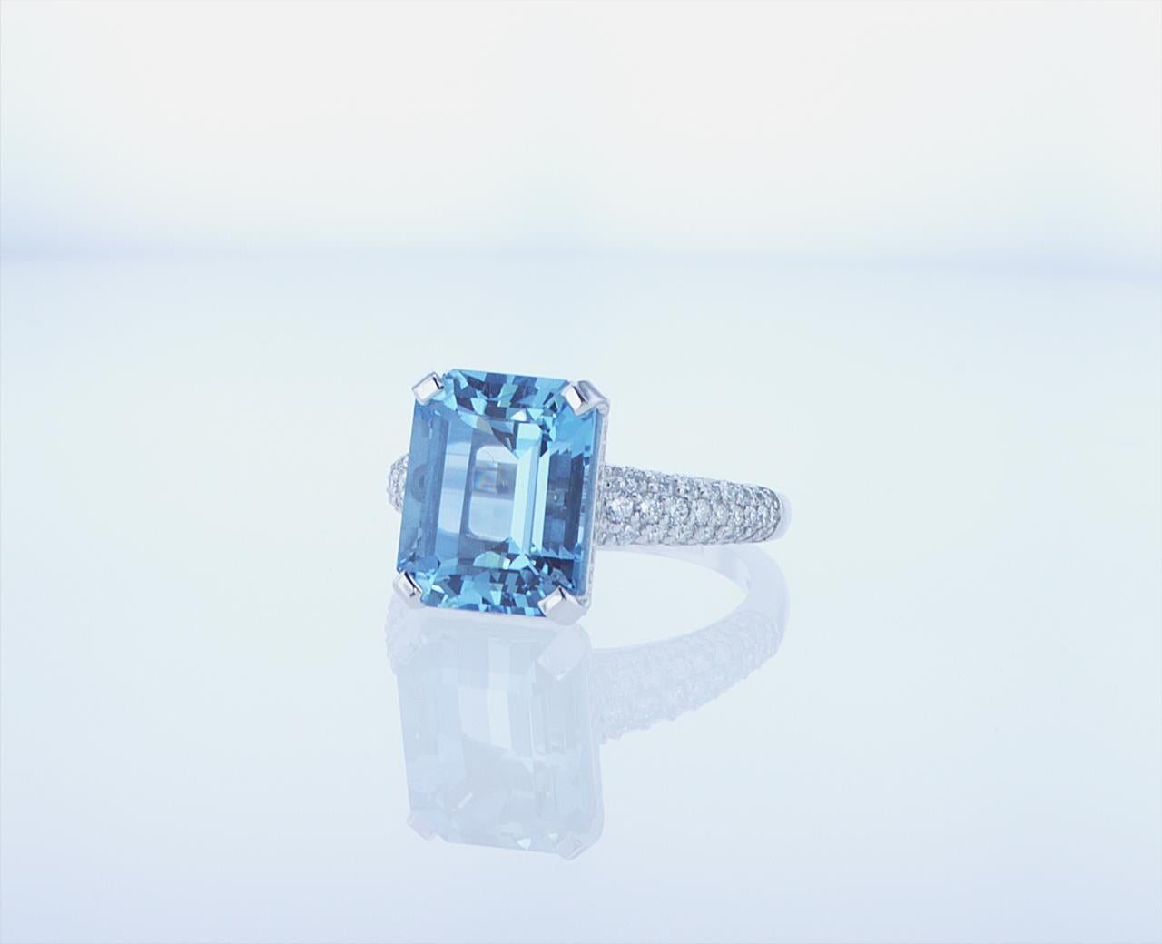 5.37ct Emerald Cut Aqua Cocktail Ring with 0.89ct Total Weight of G/H Color VS Clarity Round Brilliant Accent Diamonds.
