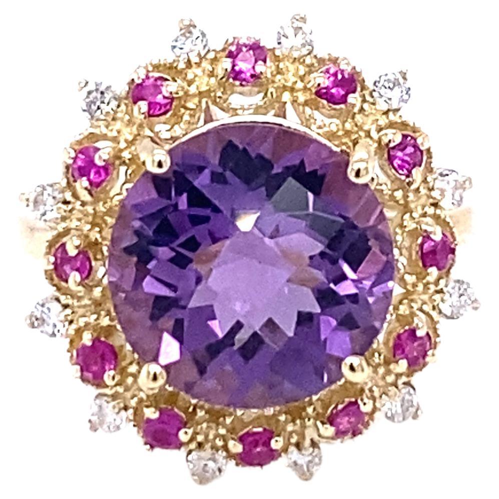 Amethyst, Pink Sapphire, and Diamond Cocktail Ring! 

Playful yet Powerful! Its like having a piece of glittery candy on your finger! This ring has a Checkers Round Cut Amethyst that weighs 4.90 Carats and is embellished with alternating 12 Pink
