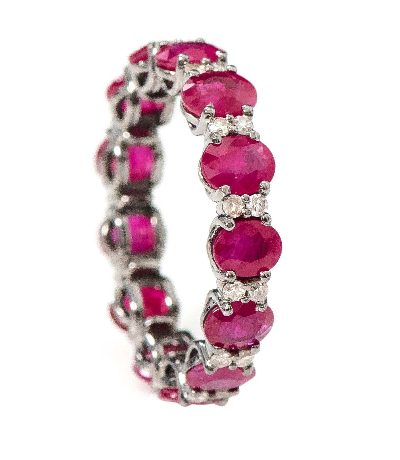 5.38 Carat Oval-Cut Ruby and Diamond Eternity Band Ring in Victorian Style
 
This Victorian period art-deco style enchanting crimson ruby and diamond band is magnificent. The solitaire horizontally placed oval shape ruby in grain prong setting is