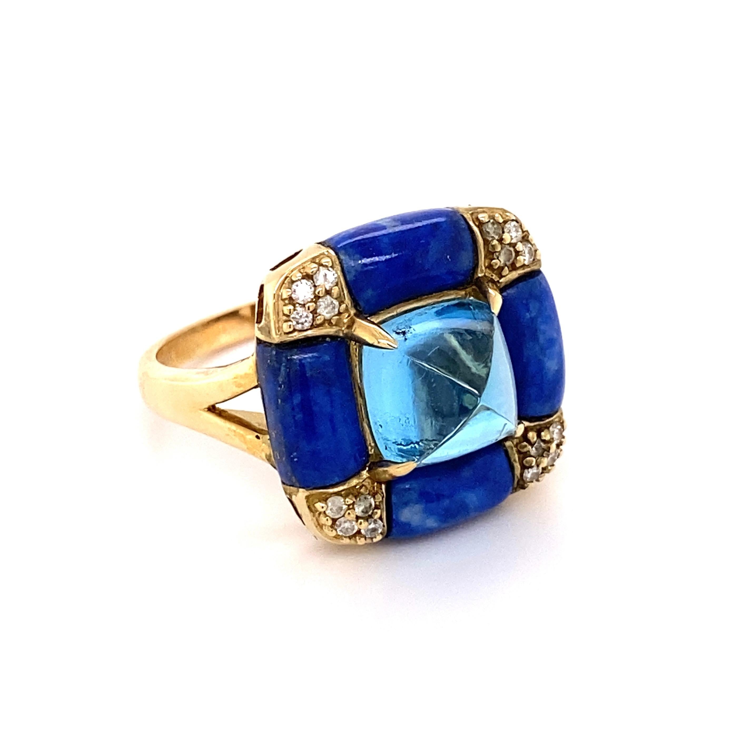 Beautiful Art Deco style Cocktail Ring, centering a securely nestled Sugarloaf Blue Topaz weighing approx. 5.38 Carats surrounded by Lapis Lazuli, approx. 7.21tcw and Diamonds, approx. 0.10tcw. The ring is Hand crafted in 14K Yellow Gold. Measuring