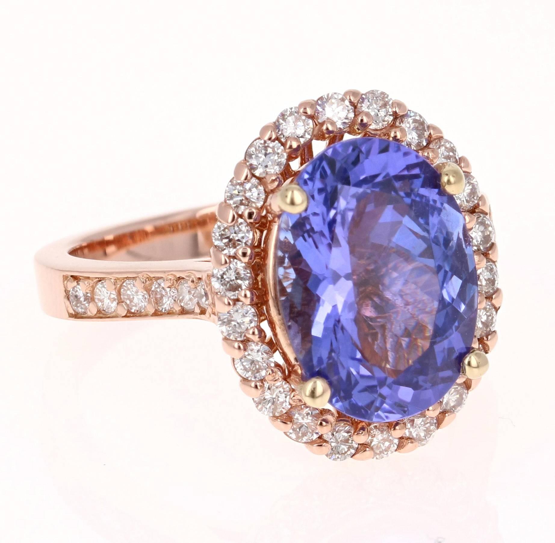 This gorgeous Tanzanite Diamond Ring has a 4.72 Carat Oval Cut Tanzanite as its center stone and has a halo of 34 Round Cut Diamonds that weigh 0.66 Carats. The Clarity of the Diamonds are SI and Color is F. The victorian inspired setting gives the