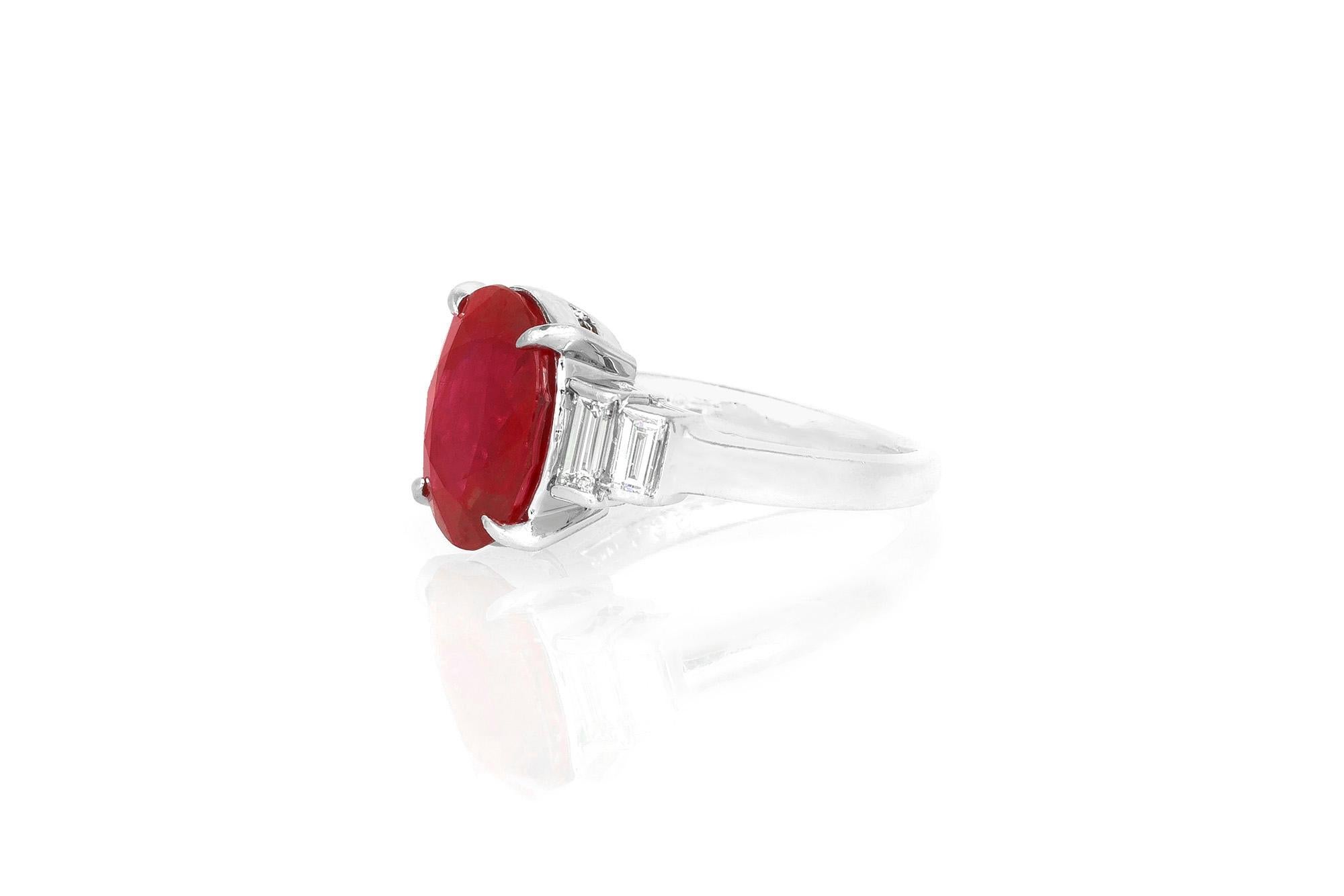 Finely crafted in platinum with a 5.39 carat Burma origin Ruby as the center stone. The ring features 4 Baguette-cut diamonds on the side weighing approximately a total of 0.50 carats.
Size 5 3/4, resizable