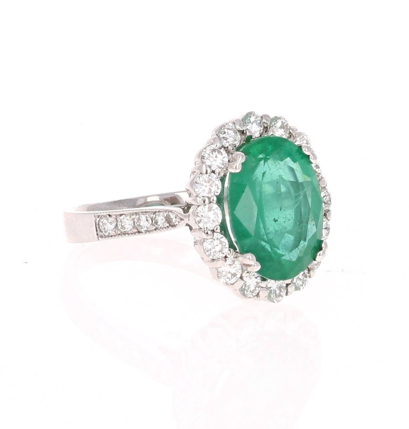 This is a gorgeous, gorgeous, gorgeous Emerald and Diamond Ring!  This 14K White Gold Ring has an Oval Cut Emerald that weighs 4.38 carats and is surrounded by a Halo of 26 Round Cut Diamonds that weigh 1.01 carat (Clarity: SI2, Color: F).  The