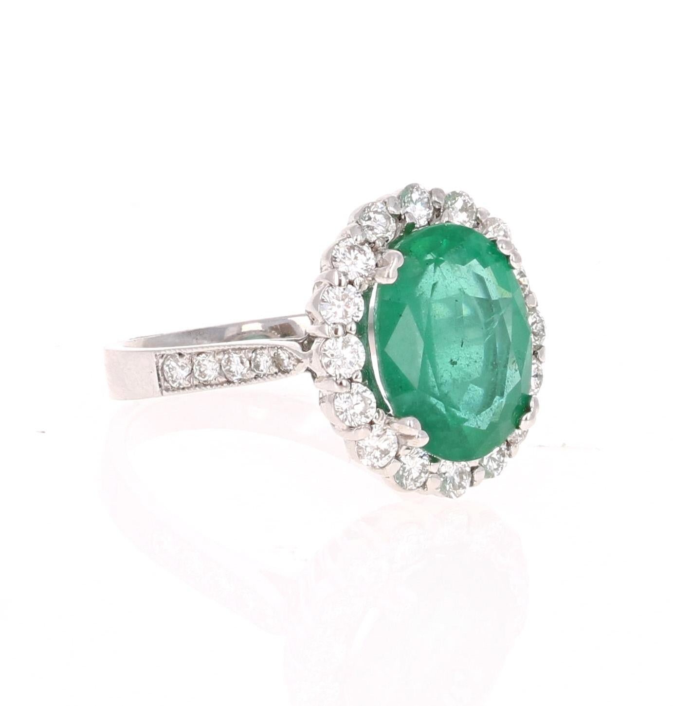 This is a gorgeous, gorgeous, gorgeous Emerald and Diamond Ring! This 14K White Gold Ring has an Oval Cut Emerald that weighs 4.38 carats and is surrounded by a Halo of 26 Round Cut Diamonds that weigh 1.01 carat (Clarity: SI2, Color: F). The total