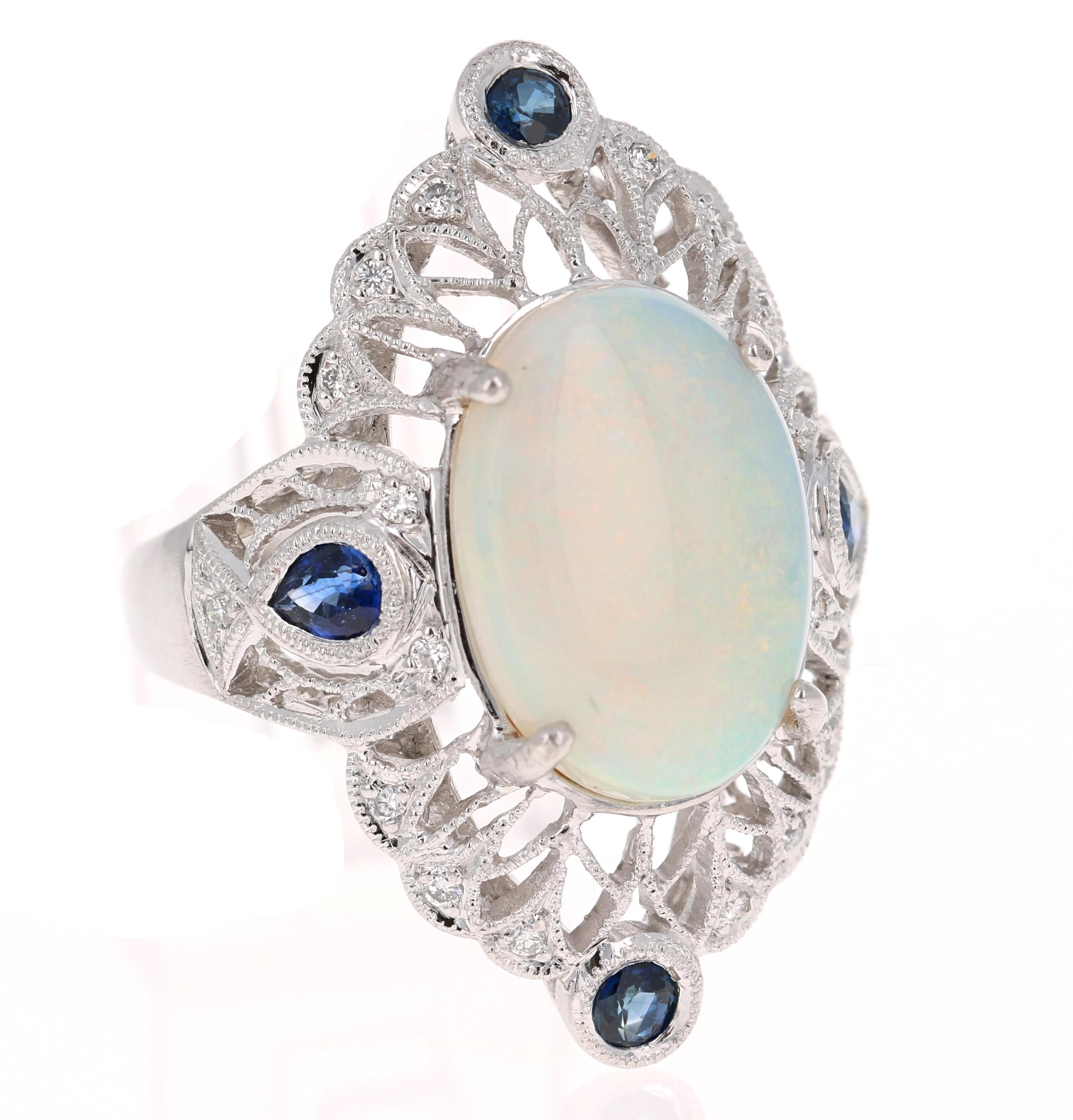 This gorgeous Victorian design inspired cocktail ring has a very large, beautiful Oval Cut Opal that weighs 4.61 Carats.  The color of the Opal is white with flashes of orange, yellow and green. The ring also has 18 Round Cut Diamonds that weigh