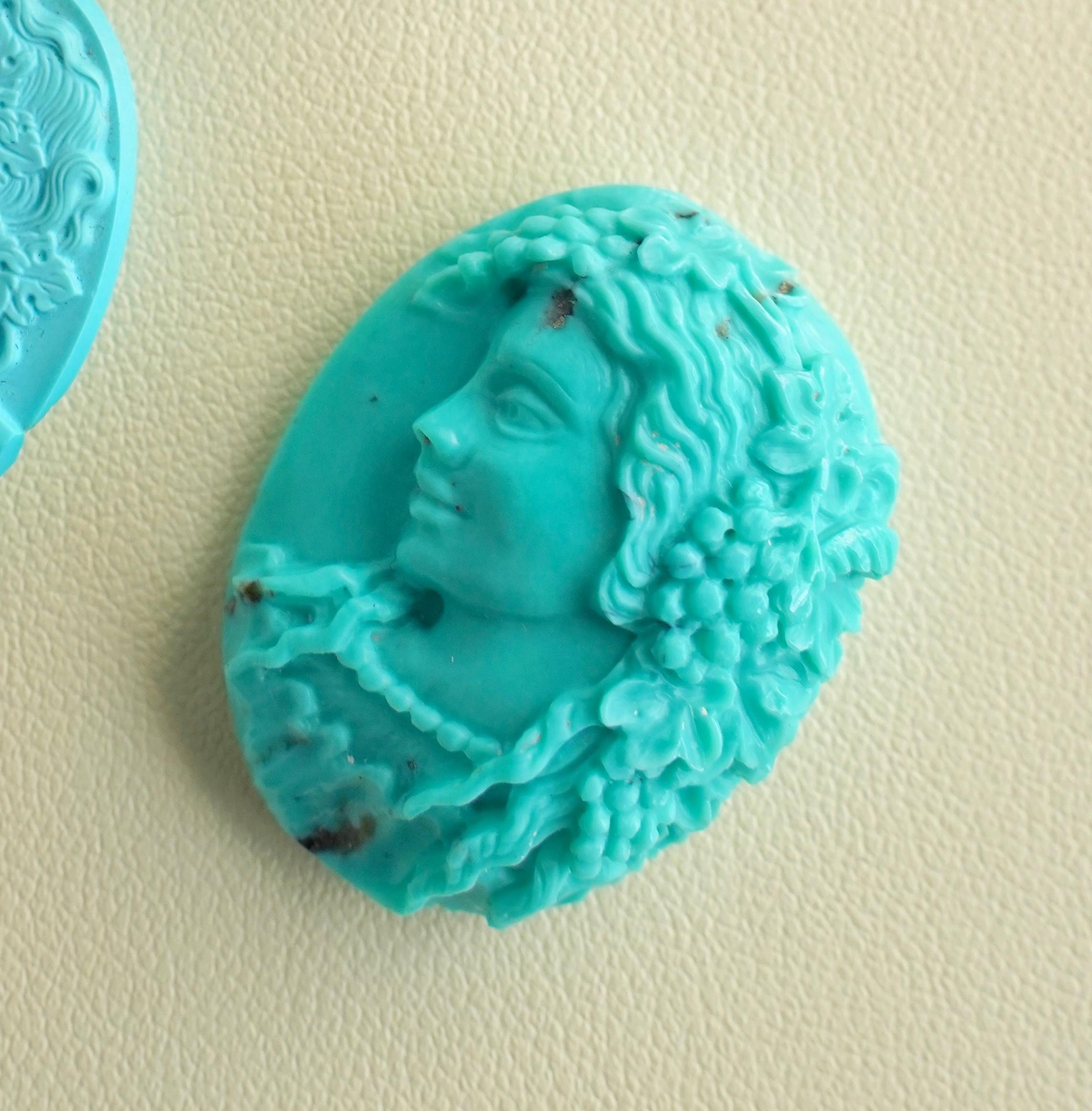 Our one-of-a-kind hand-carved Lady portrait cameo on natural Arizona Turquoise is a breathtaking work of art crafted by our expert lapidary artist in Jaipur. With exceptional skill and an eye for detail, the lapidary artist has transformed a raw