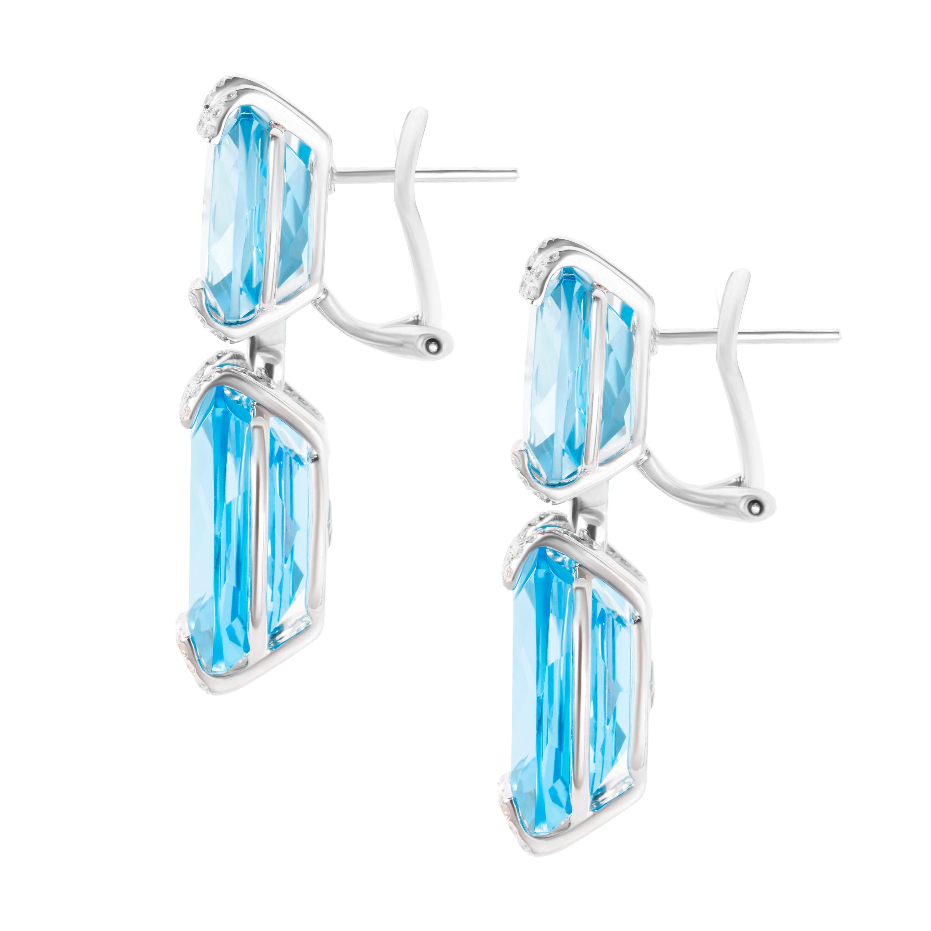 Set in 18K white gold, these drop earrings feature four cushion-cut blue topaz gemstones (total carat weight 53.96 carats) and accented with 0.44 carats of brilliant round diamonds.  Earring length 3.5cm.

Composition: 
18K White Gold 
4 Cushion-cut
