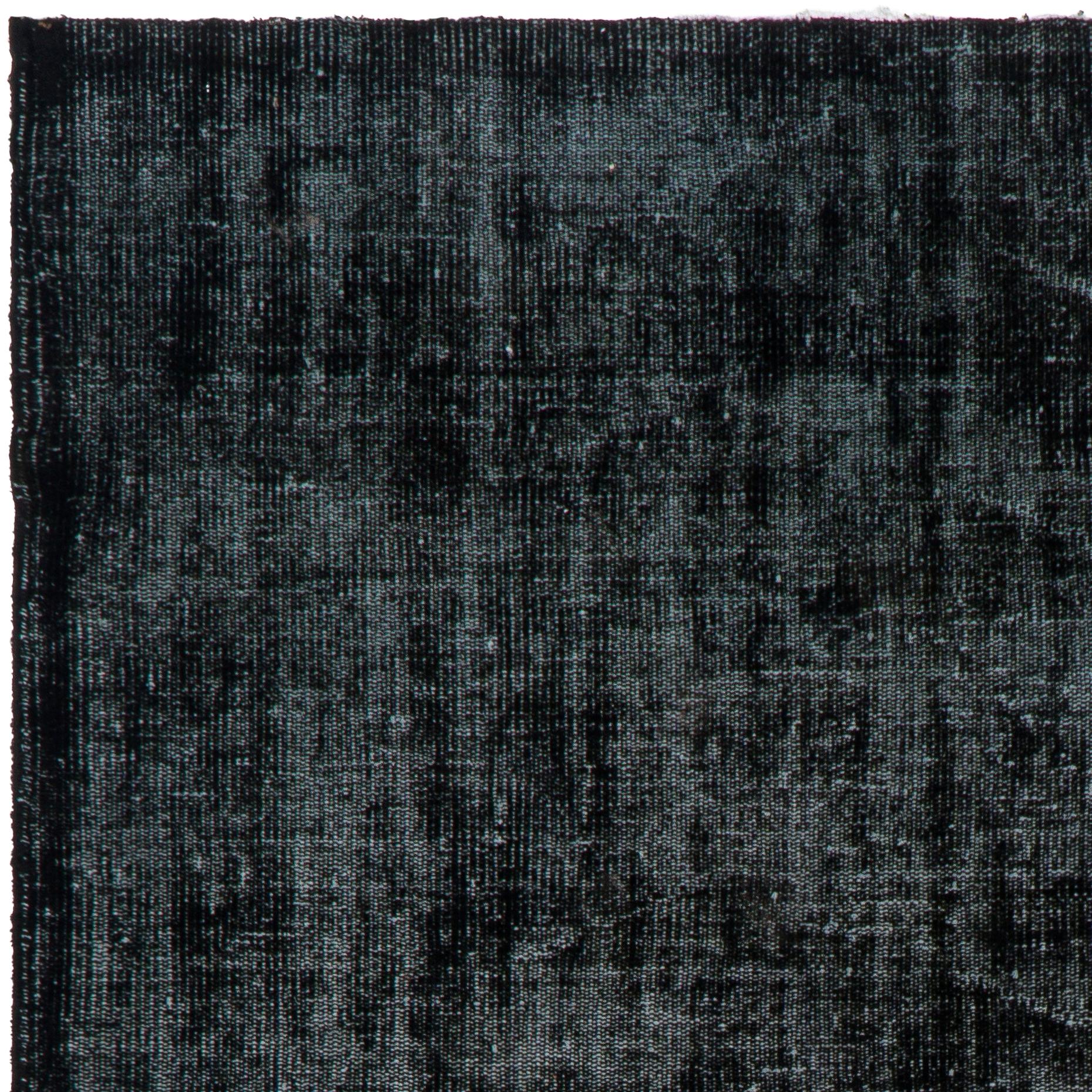 A vintage Turkish area rug over-dyed in black color for modern home and office.
Finely hand knotted, low wool pile on cotton foundation.
The rug is in very good condition, professionally-washed, sturdy and suitable for areas with high foot