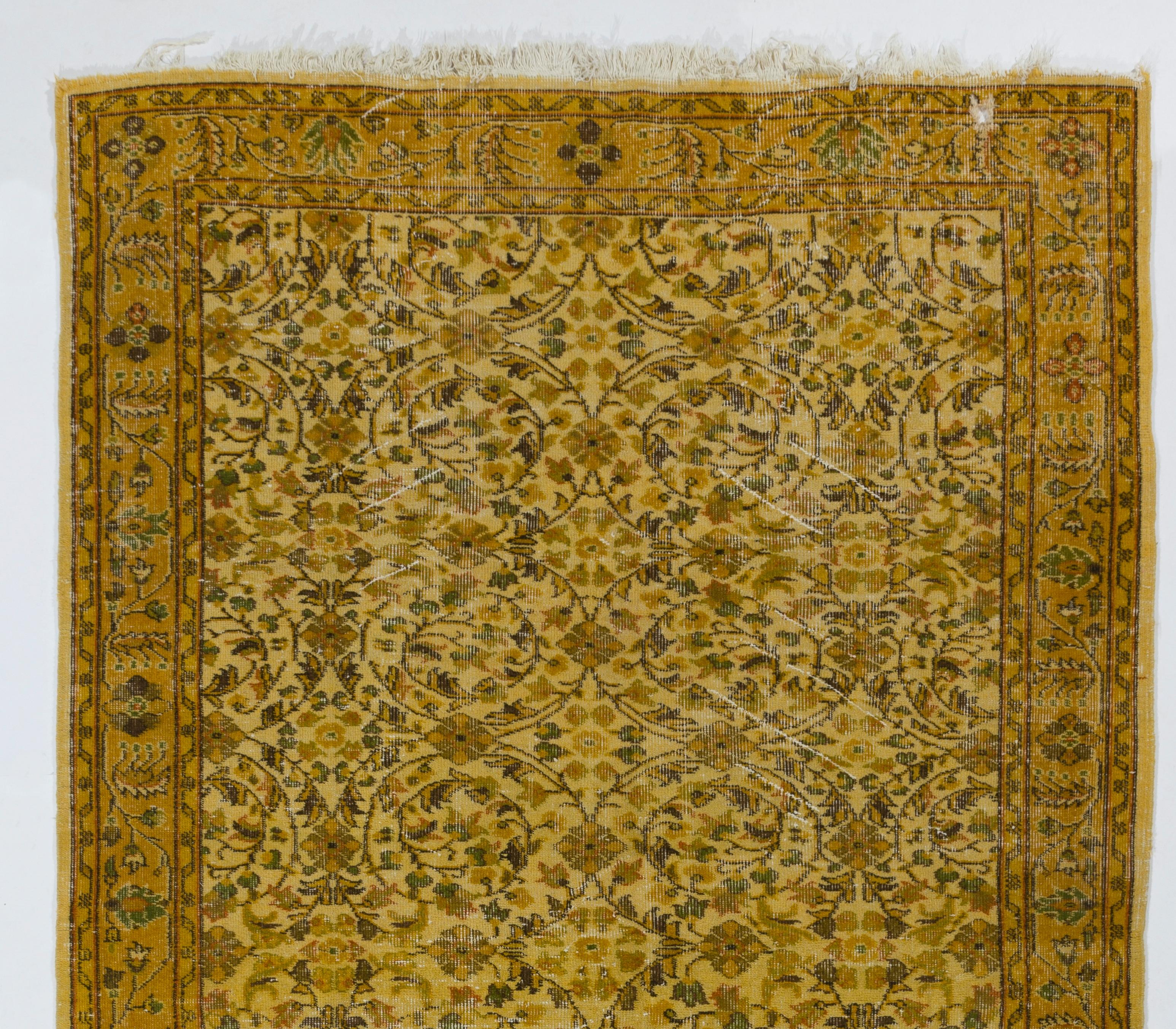 A vintage Turkish area rug over-dyed in yellow color for contemporary interiors.
The rug is finely hand-knotted, has low wool pile on cotton foundation. It is in very good condition, professionally washed, sturdy and suitable for areas with high