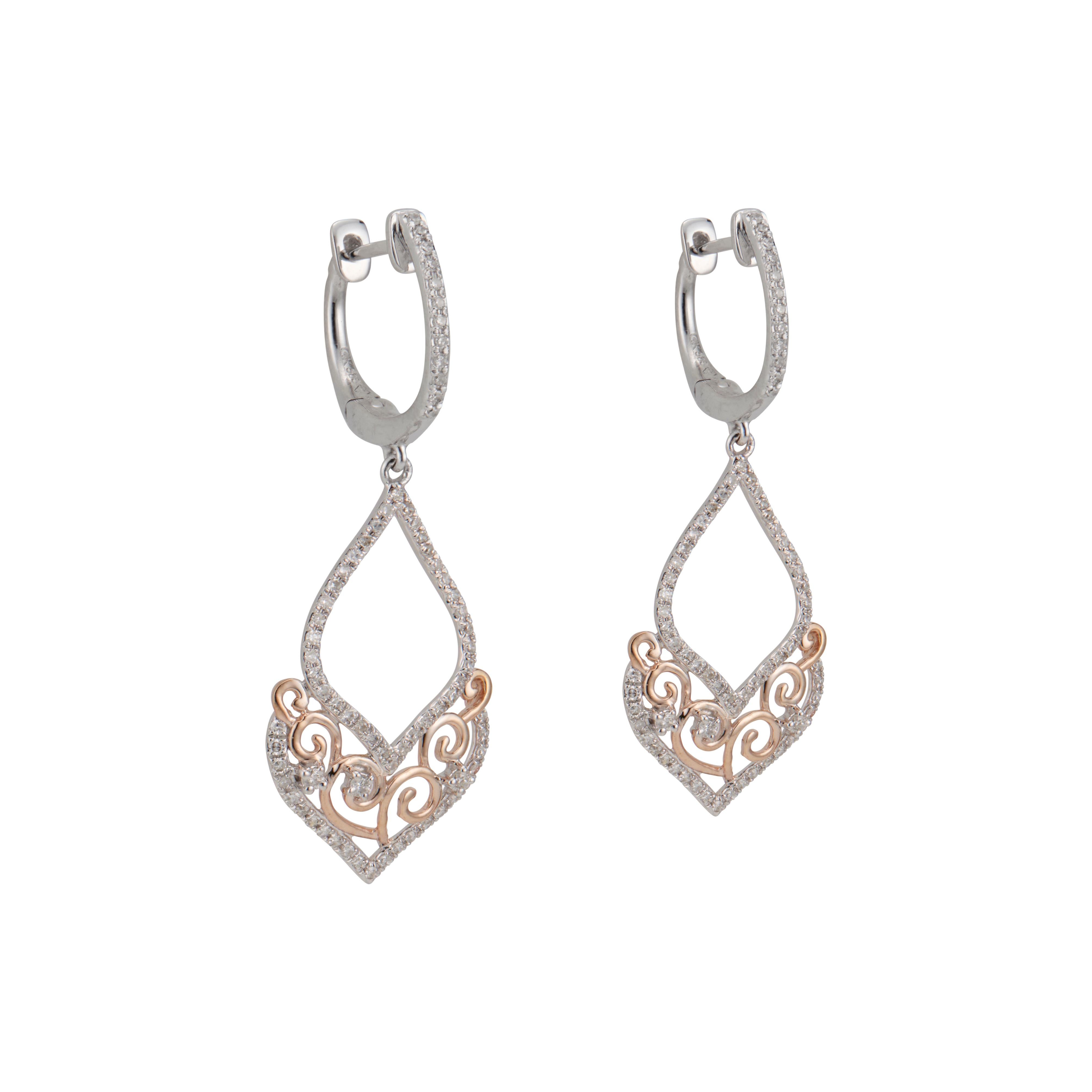 Diamond dangle earrings. 148 round cut diamonds set in 14k white and rose gold open work setting. 

148 round full cut diamonds, approx. total weight .54cts, H, VS – SI
14k white gold
14k rose gold 
Tested: 14k
3.9 grams
Top to bottom: 39.56mm or