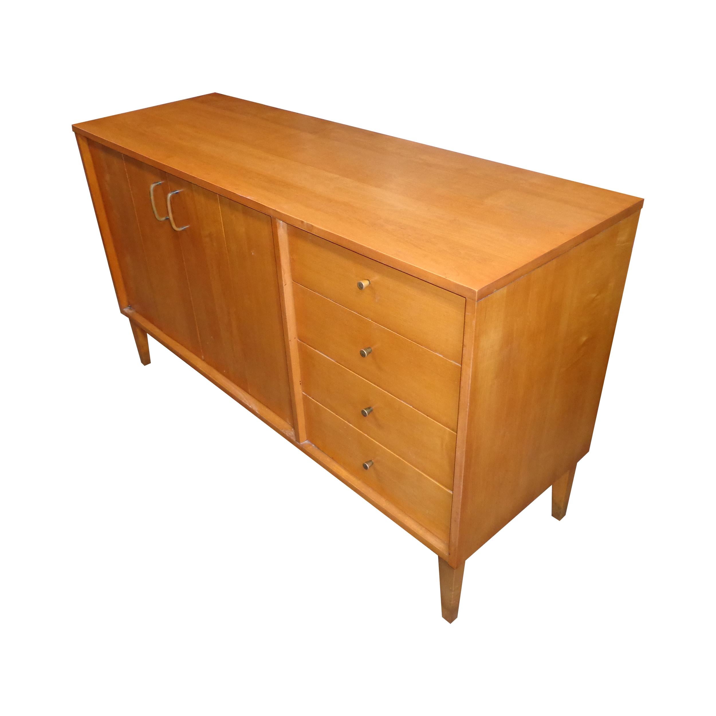 54” Paul McCobb Planner Group credenza

A rare piece in maple from the Planner Group by Paul McCobb for Winchedon. A very versatile piece featuring 4 drawers and concealed shelving. Nickel pulls and tapered legs.
Previous label removed. See photo