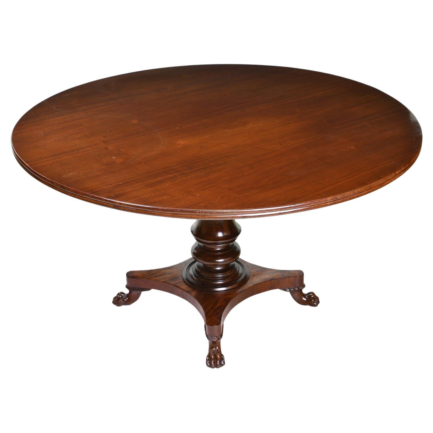A very beautiful dining table in fine mahogany with round top supported on a turned column that rests on a quatre-form base with carved lion's paw feet. While the base dates to the reign of Christian VIII of Denmark, circa 1835, the round top which