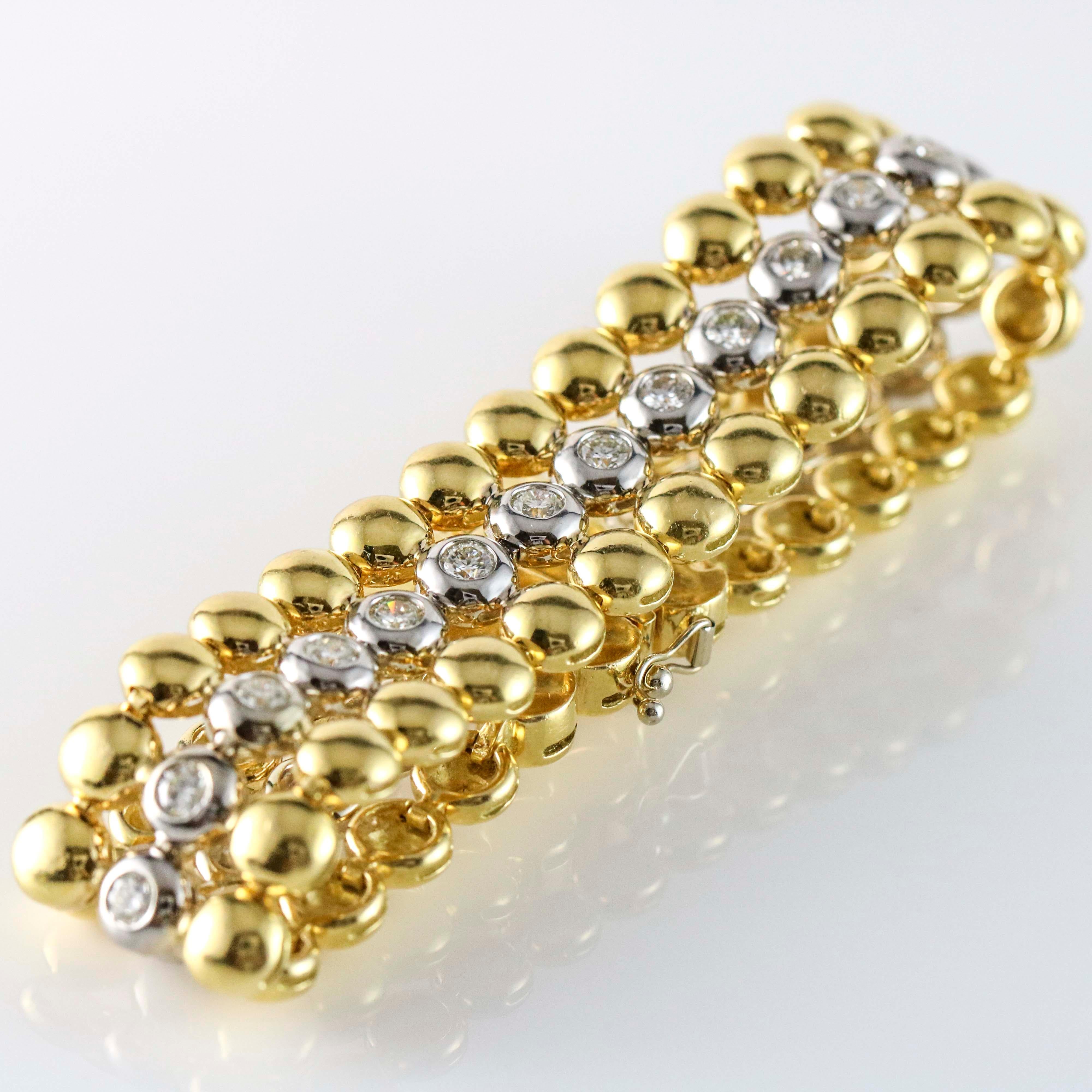 3-row disc link diamond bracelet in 18k white and yellow gold. The bracelet is bezel set with 27 round brilliant cut diamonds. Total carat weight, 5.40 carats. Diamond, color, F-G, clarity, VS-SI. 