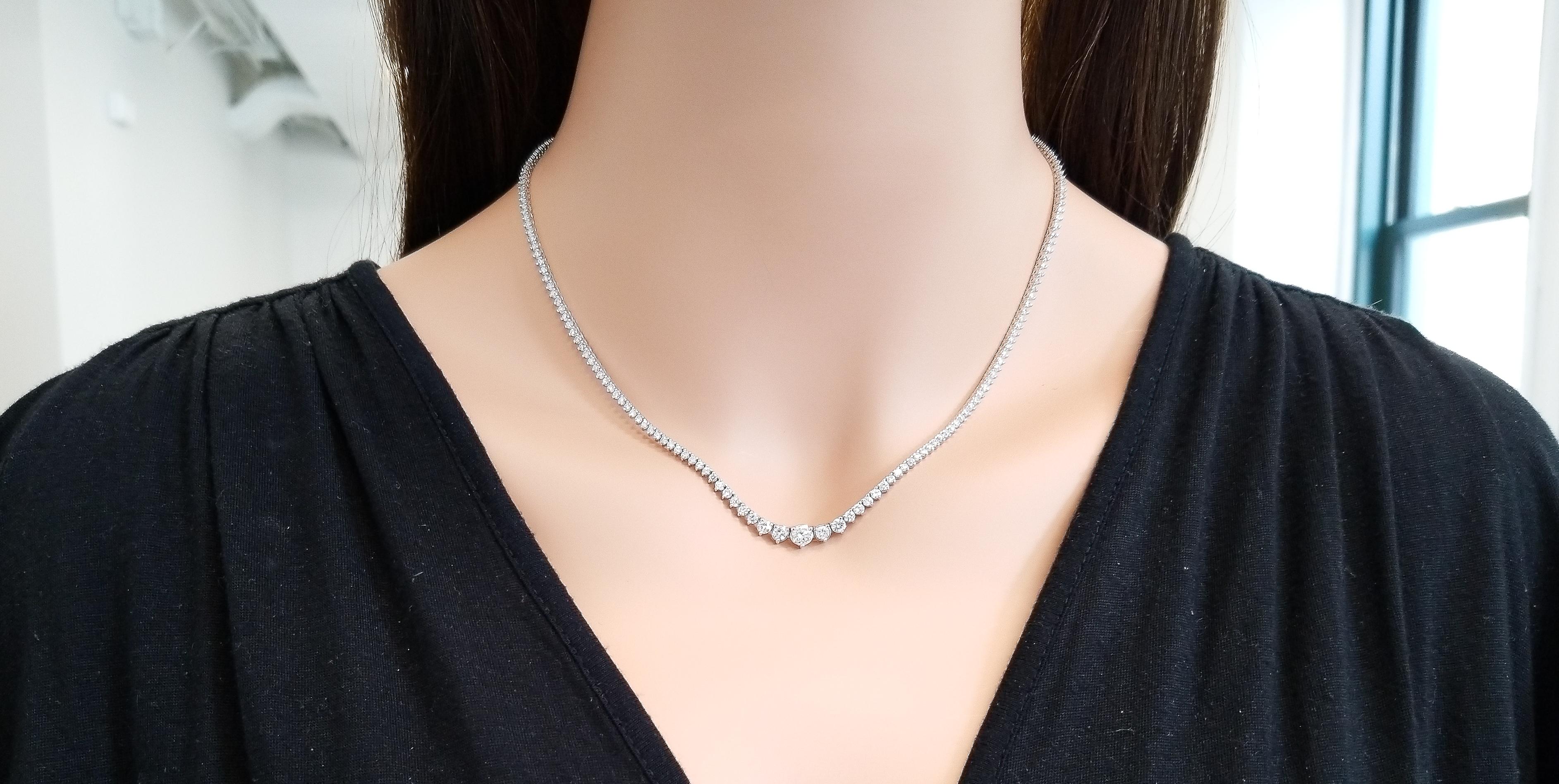This luxurious 18 inch RIVIERA necklace is timeless elegance. A total of 223 glittering round brilliant cut diamonds are 3-prong set in graduated size with the largest in the middle from end to end in one row eternity style totaling 5.40 carats. A