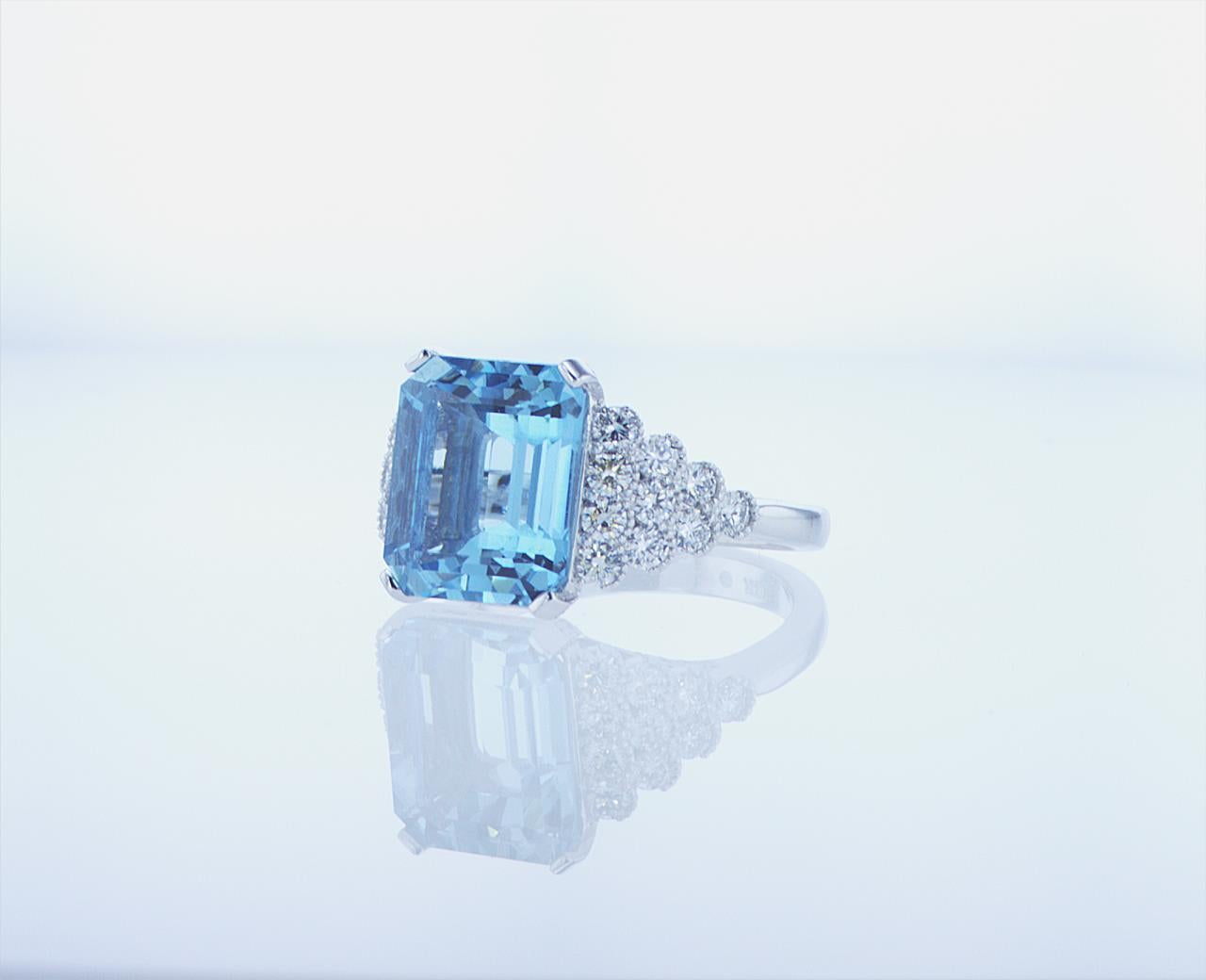 5.40ct Emerald Cut Aqua Ring featuring 1.05ct Total Weight of G/H Color, VS Clarity Round Brilliant Diamonds in an 18k White Gold with Palladium Mounting.
