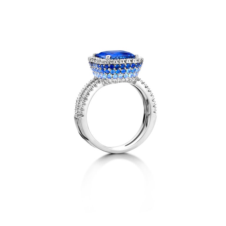One of a kind “Alice” ring in 18K white gold 7,7g set with 1 natural, eyeclean certified Ceylon blue sapphire in cushion cut 4,05Ct, diamonds in brilliant cut 0,65Ct (LC-D quality) and sapphires in brilliant cut 1,35Ct.

Because every sapphire has