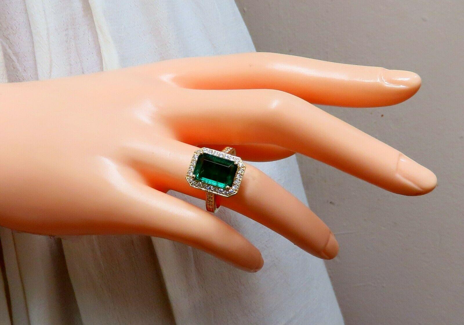 Rectangular Deck Gilt Mod Deco Green.

4.10ct. Natural Emerald cut, Emerald Ring

Emerald: 11.6 x 8.2mm 

Transparent & Vivid Green 

1.30ct. Diamonds.

Round & full cuts 

G-color Vs-2 clarity.  

14kt. yellow gold

5.9 grams

Ring Current size: