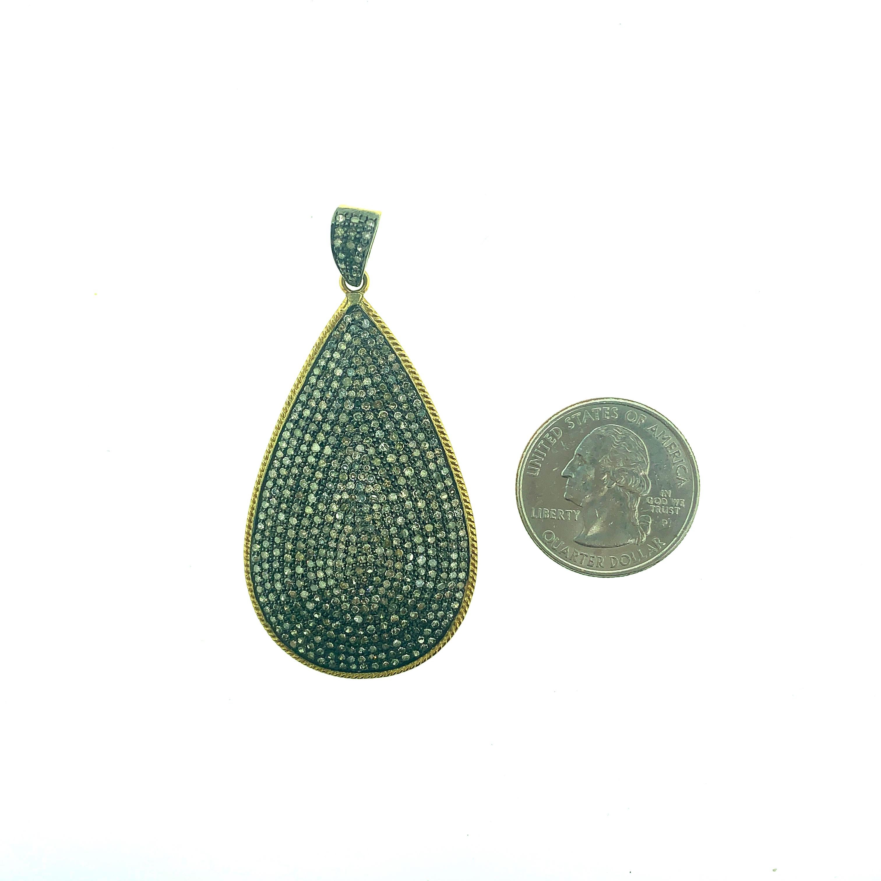5.40 ct Pave Champagne Diamond Teardrop Pendant set in Oxidized Sterling Silver surrounded by 14KT Gold rim and back of bail in 14KT Gold. This 2.5 Inch long (including bail) is made in India. 
Diamonds - 5.40 ct Champagne Diamonds
Dimension : 2.5