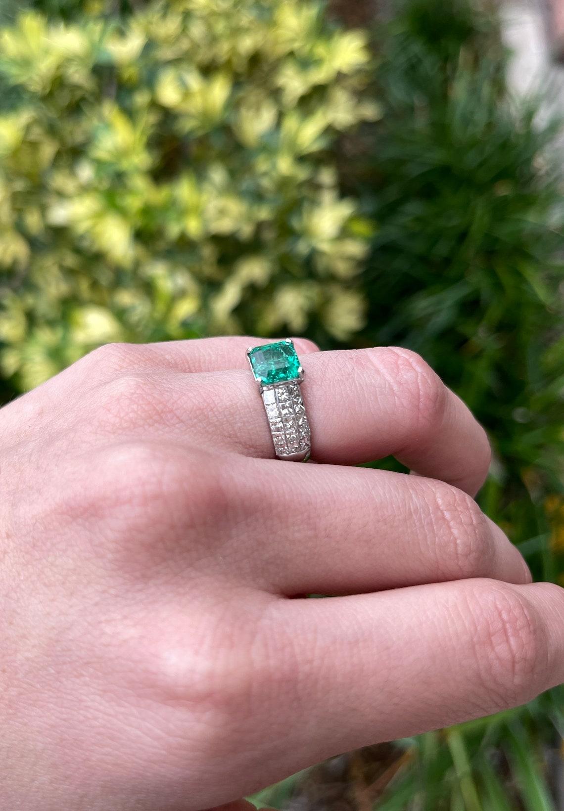 thick gold band with emerald cut diamond