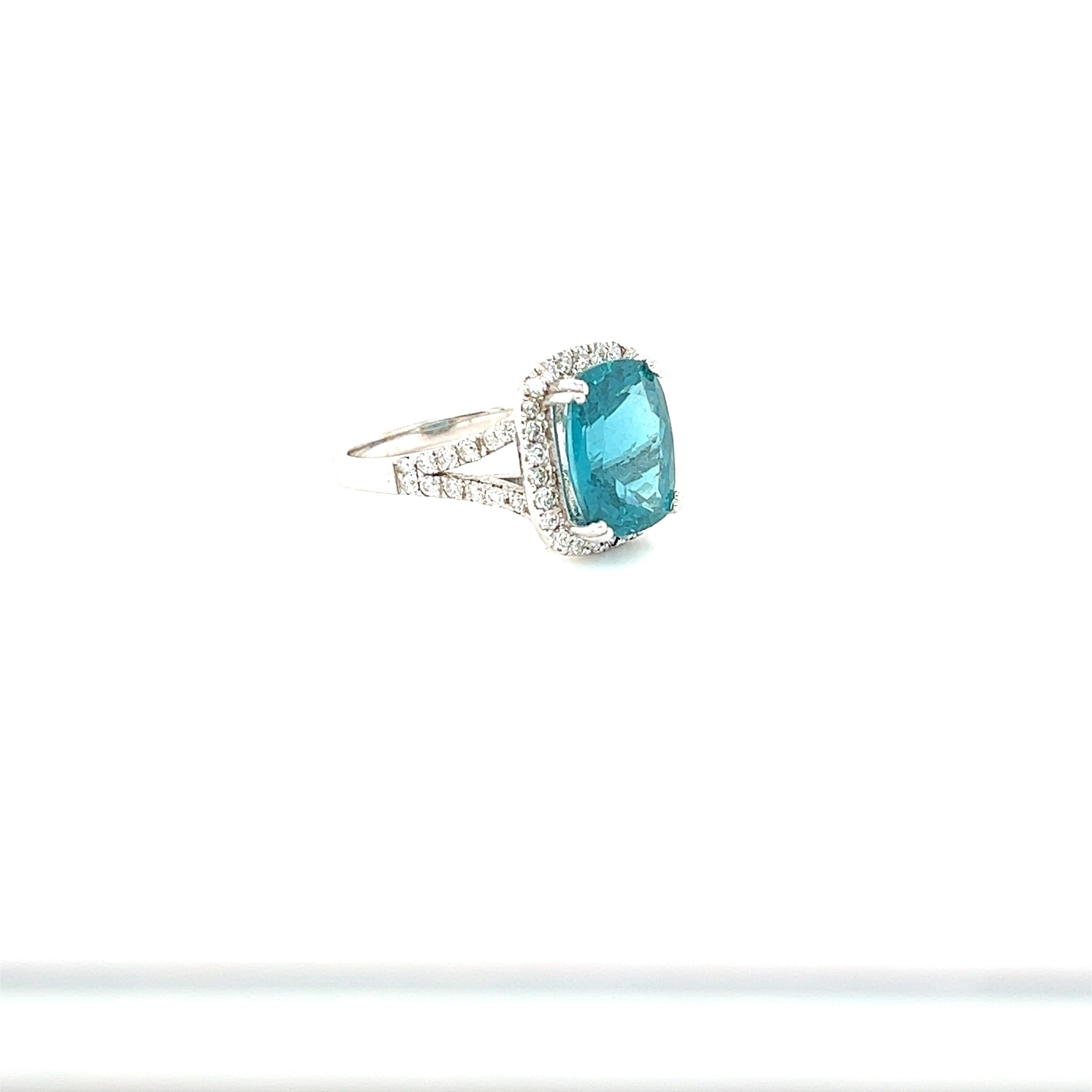This ring has a Natural Cushion Oval Cut Apatite that weighs 4.75 Carats and has 50 Round Cut Diamonds that weigh 0.67 Carats. The total carat weight of the ring is 5.42 Carats. 
The clarity and color of the diamonds are SI-F. 

The ring is set in