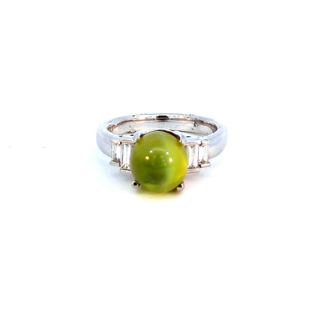 Introducing our captivating 5.42 Carat Cat's Eye Ring, a masterpiece that beautifully combines the enchanting allure of a 5.24-carat cat's eye chrysoberyl with the subtle sparkle of 0.30 carats of diamonds, set in a luxurious platinum band. This