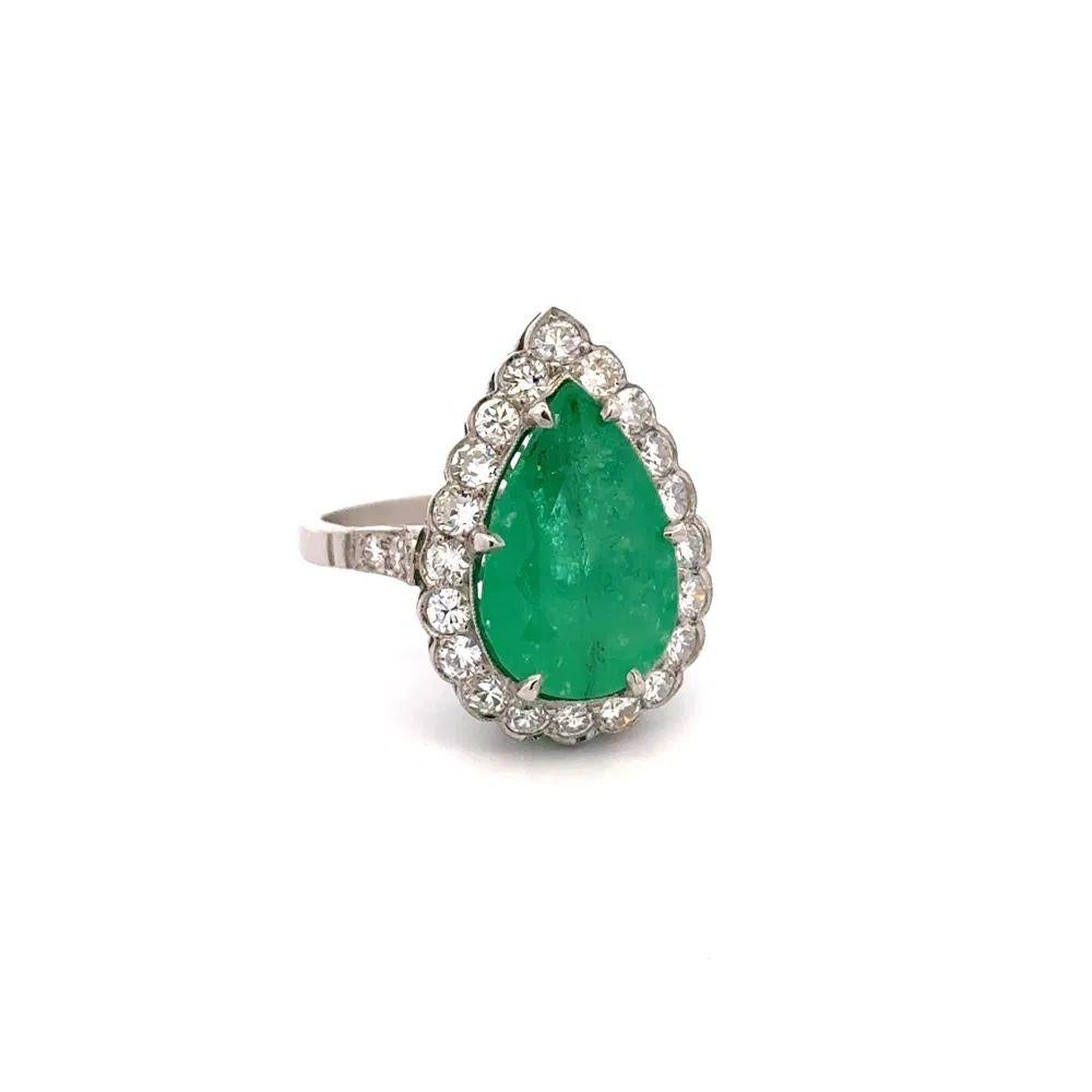 Simply Beautiful! Finely detailed Mid Century Modern Pear Green Emerald and Diamond Platinum Vintage Mid Century Modern Cocktail Ring. Centering a securely nestled Hand set 5.42 Carat. Surrounded by Round Brilliant Cut Diamonds, weighing approx.