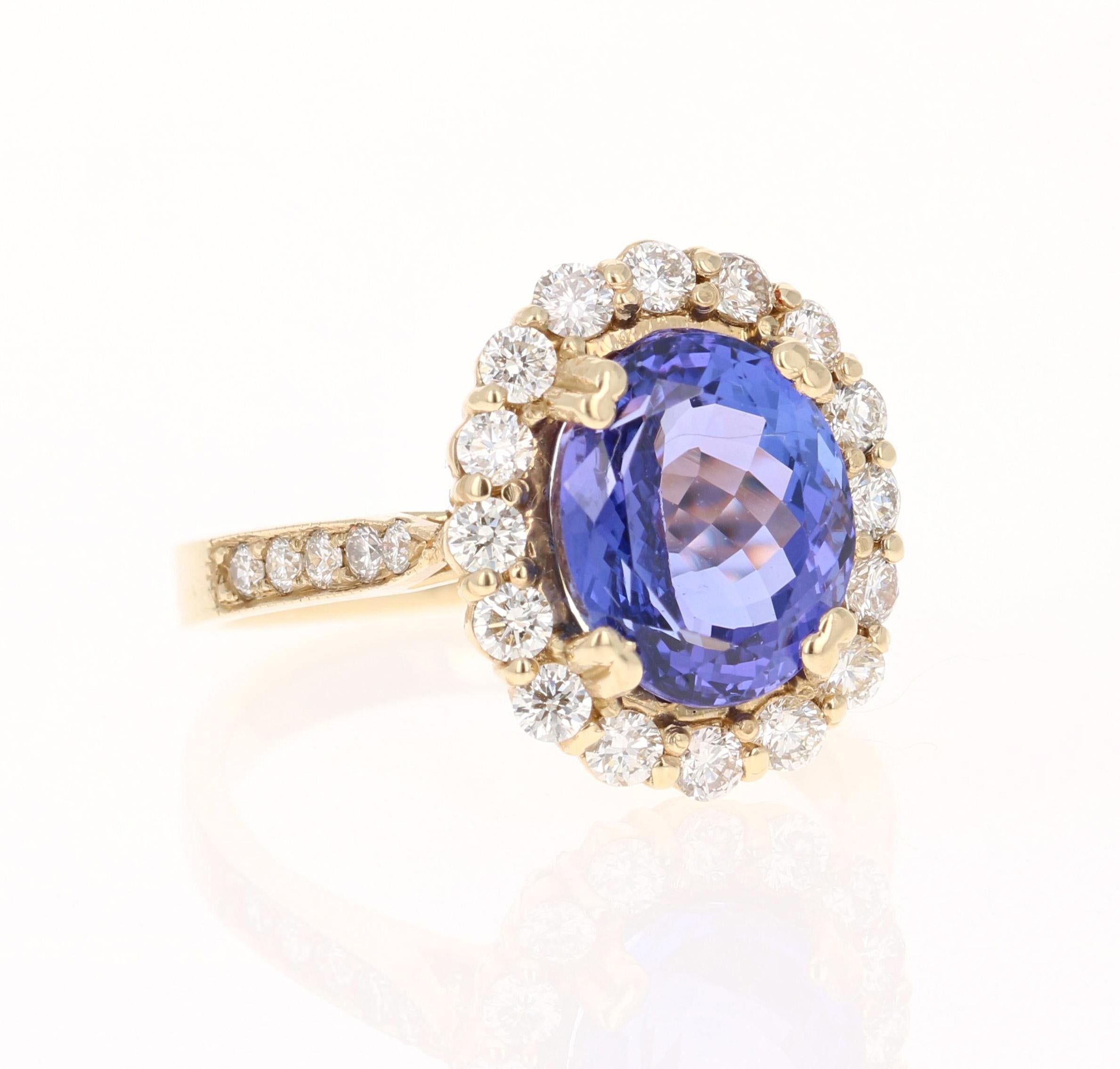 This beautiful ring has a vivid 4.56 Carat Oval Cut Tanzanite. The Tanzanite is surrounded by 26 Round Cut Diamonds that weigh 0.86 carats. (Clarity: VS, Color: H) The total carat weight of the ring is 5.42 carats. The Oval Cut Tanzanite measures at