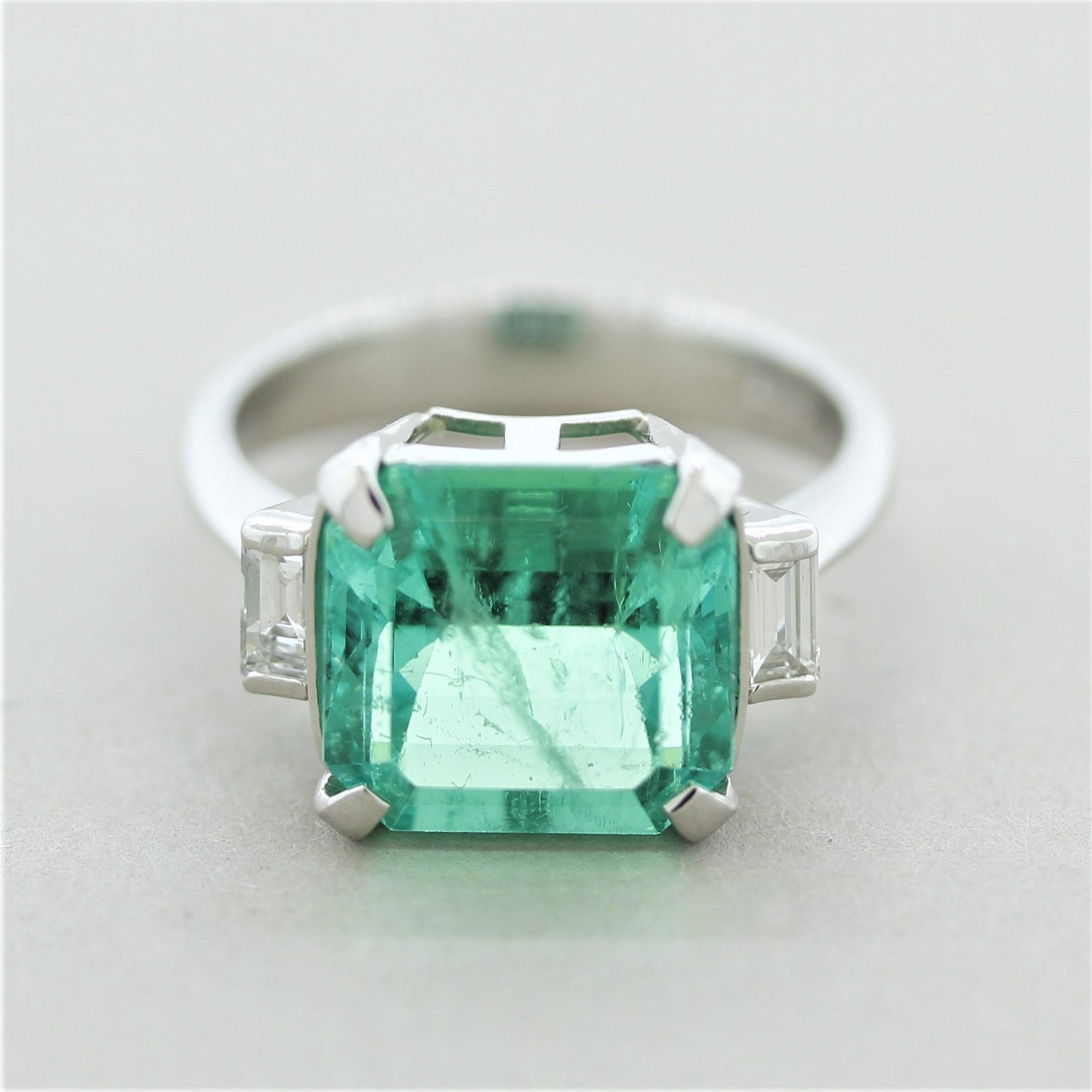 A rare and fine emerald from the famed mines in Colombia weighing 5.43 carats takes center stage! It has a bright and vibrant green color and is relatively free from inclusions compared to most fine gem quality emeralds. It is certified by the GIA