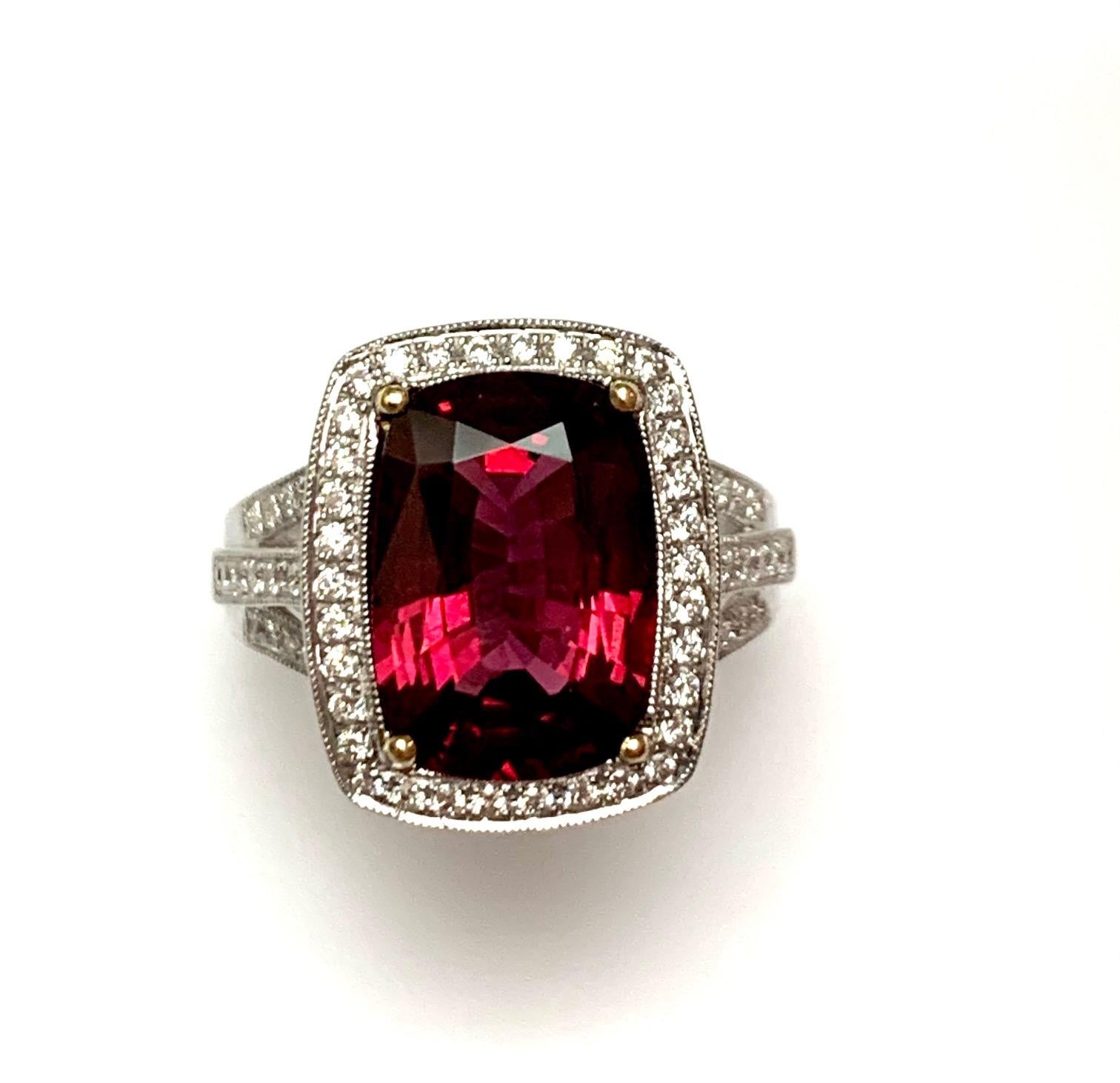5.43 Carat Cushion shape red spinel set in 18kw ring  along with 0.47 ct G-h cealn vs Diamonds pave set around ,in the gallery, and half way on the triple split shank .