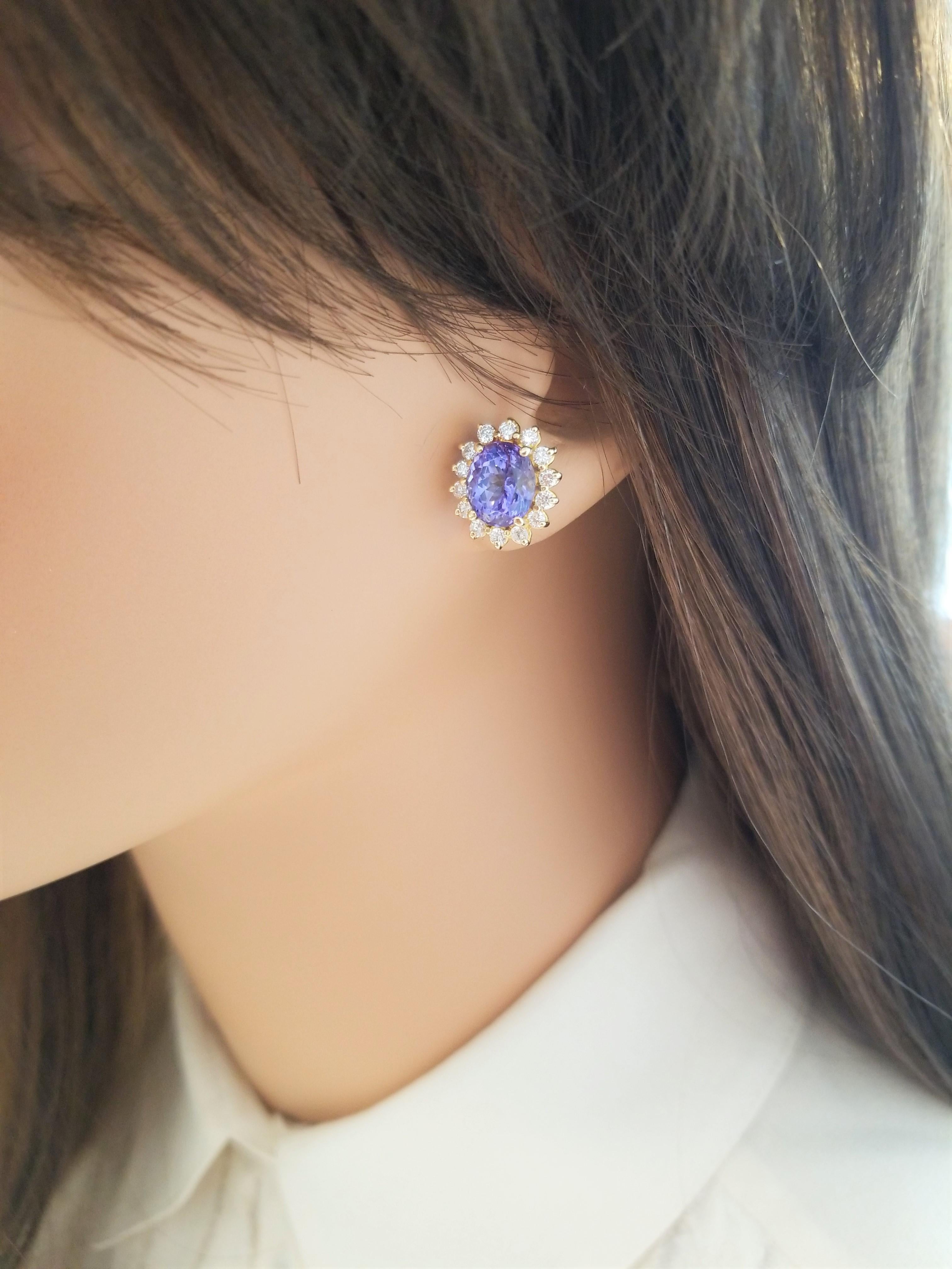 Add a flash of vivid purplish-blue to any ensemble with these spectacular and sparkling tanzanite and diamond earrings. This pair of earrings features 5.43 carat total of purplish-blue tanzanite, from Tanzania, is framed by 0.85 carat total weight