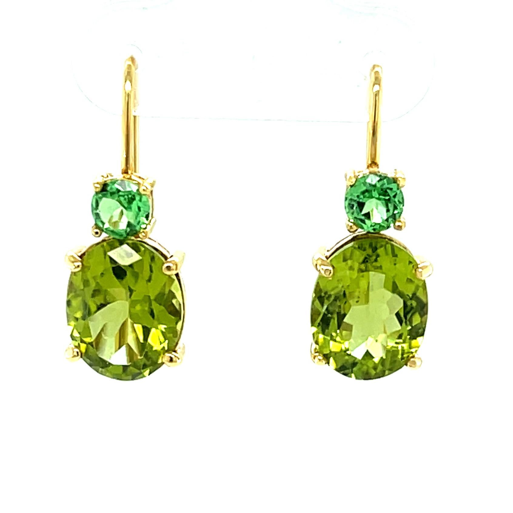 Our Color Pairings Collection offers effortless style, high quality, and unusual gemstones for endless versatility. These handmade 18k yellow gold earrings feature lovely oval shaped peridots paired with bright round tsavorite garnets for a unique