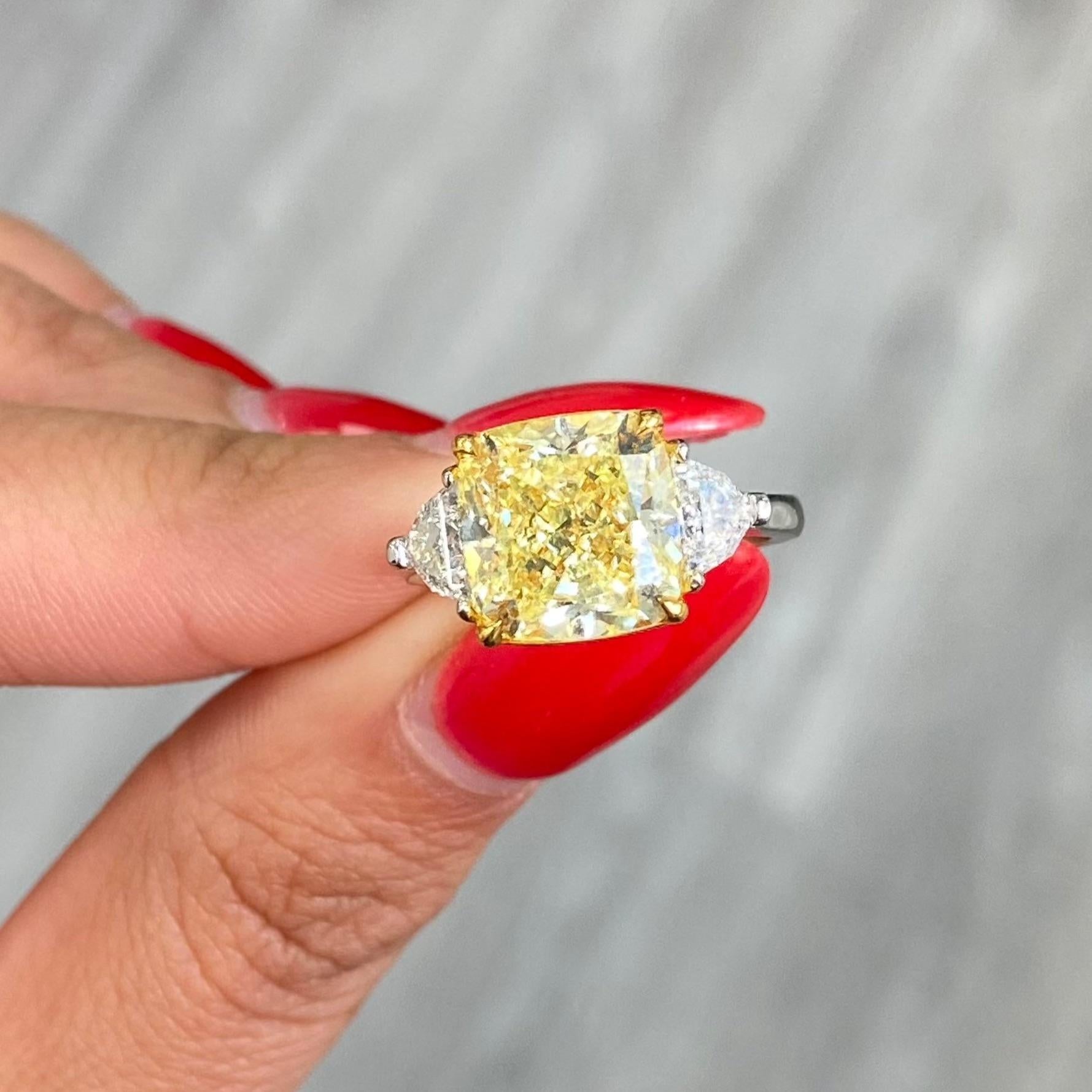 5.44 Carat
Fancy Yellow
Cushion Cut Center Diamond
VVS2 Clarity
Excellent and Excellent Cutting
Medium Blue Fluorescence 
0.56 Carats of Side Epaulettes
GIA Certified Diamond
Crafted in Platinum & 18k Yellow Gold
Handmade in NYC

This piece can be