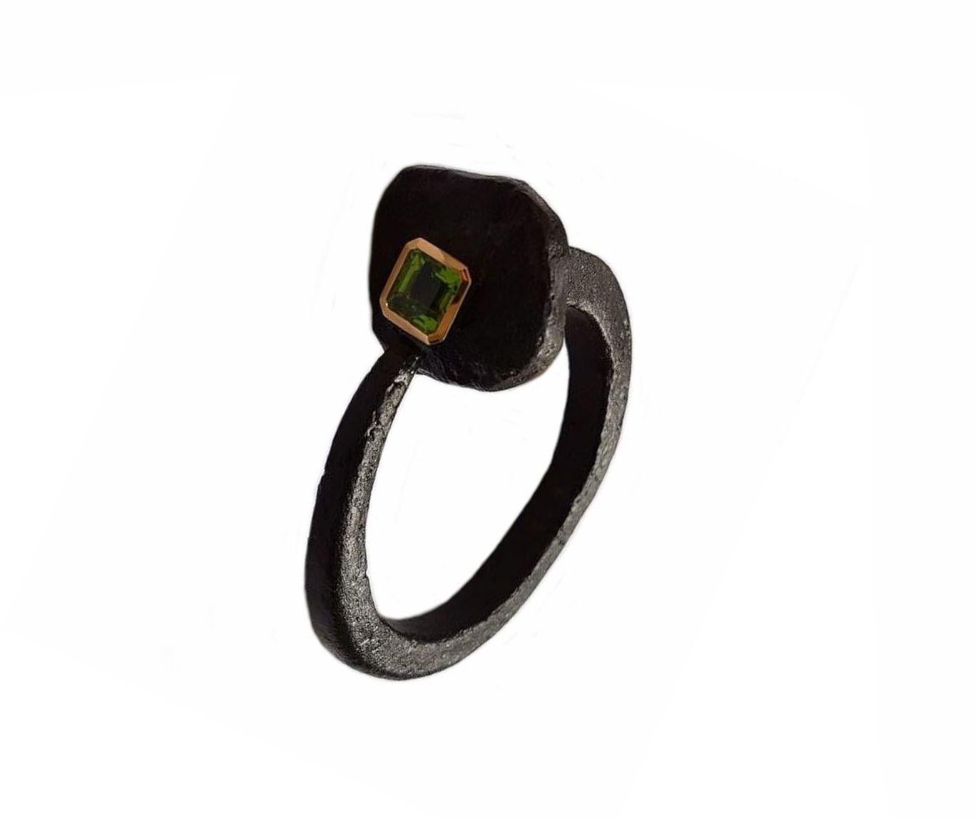 This unusual bangle - designed by Guenter  Krauss - is made of an old iron ship nail. An exquisite 5.45 carat peridot set in 18 carat gold adorns the head of the nail.
A vanguard piece of jewelry for the sophisticated lady!
Wear daytime or with