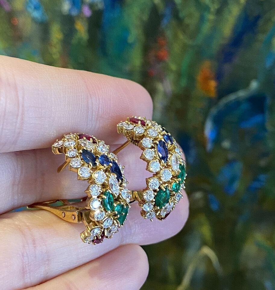Ruby, Emerald, Sapphire and Diamond Half-hoop Earrings in 18K Yellow Gold

Italian made Elegant Half-hoop Estate Earrings
feature Diamonds, Rubies, Sapphires and Emeralds in Round and Marquise shapes set in 18k Yellow Gold. The earrings are secured