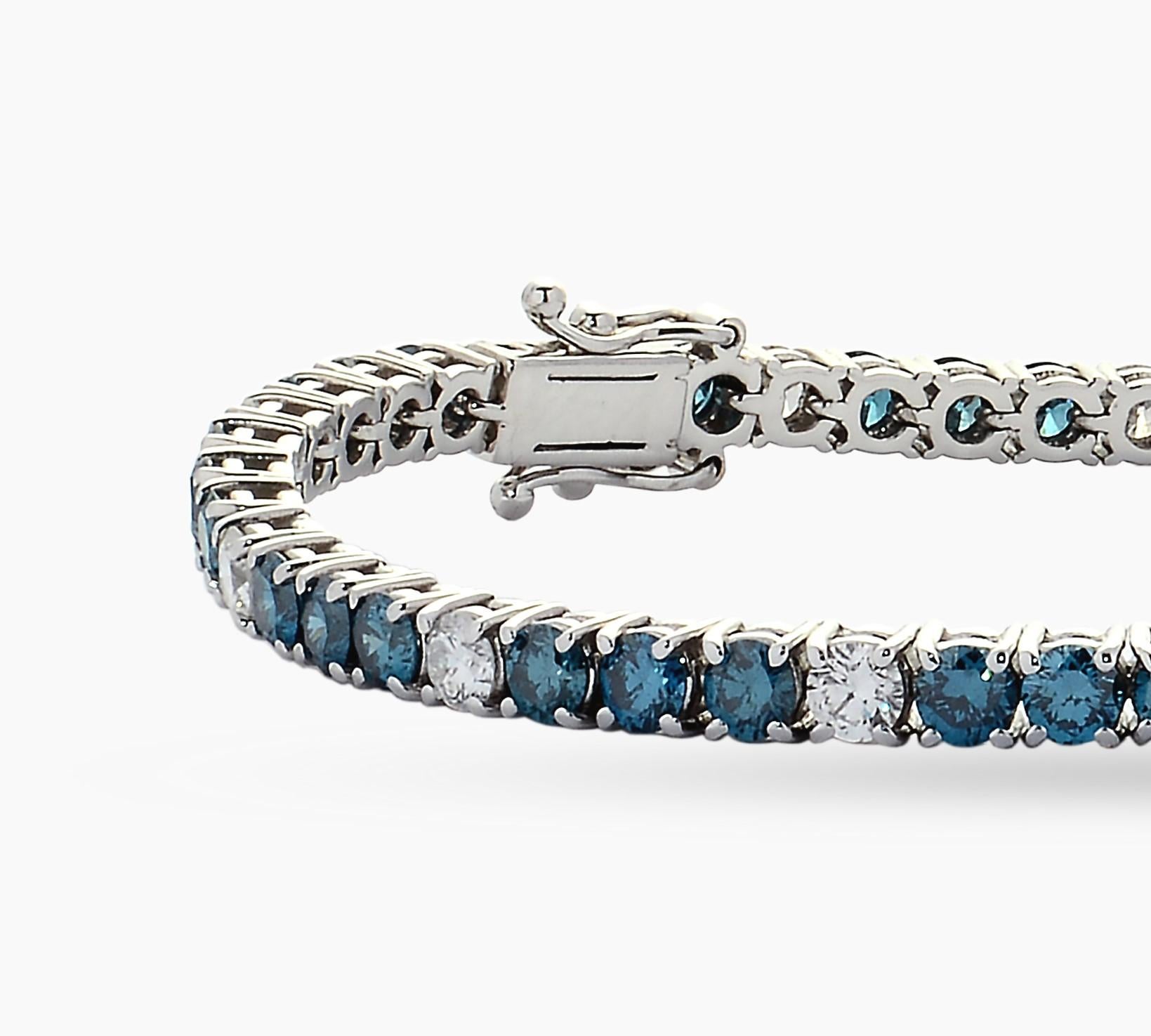 Stunning 18K white gold natural blue diamond tennis bracelet. This riviera bracelet is set with 42 natural blue brilliant cut diamonds and 15 natural white brilliant cut diamonds. This classic tennis bracelet is set with 4 prong settings for maximum