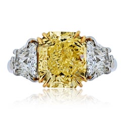 5.47 carat Radiant Cut Fancy Yellow Diamond Three Stone Diamond Engagement Ring